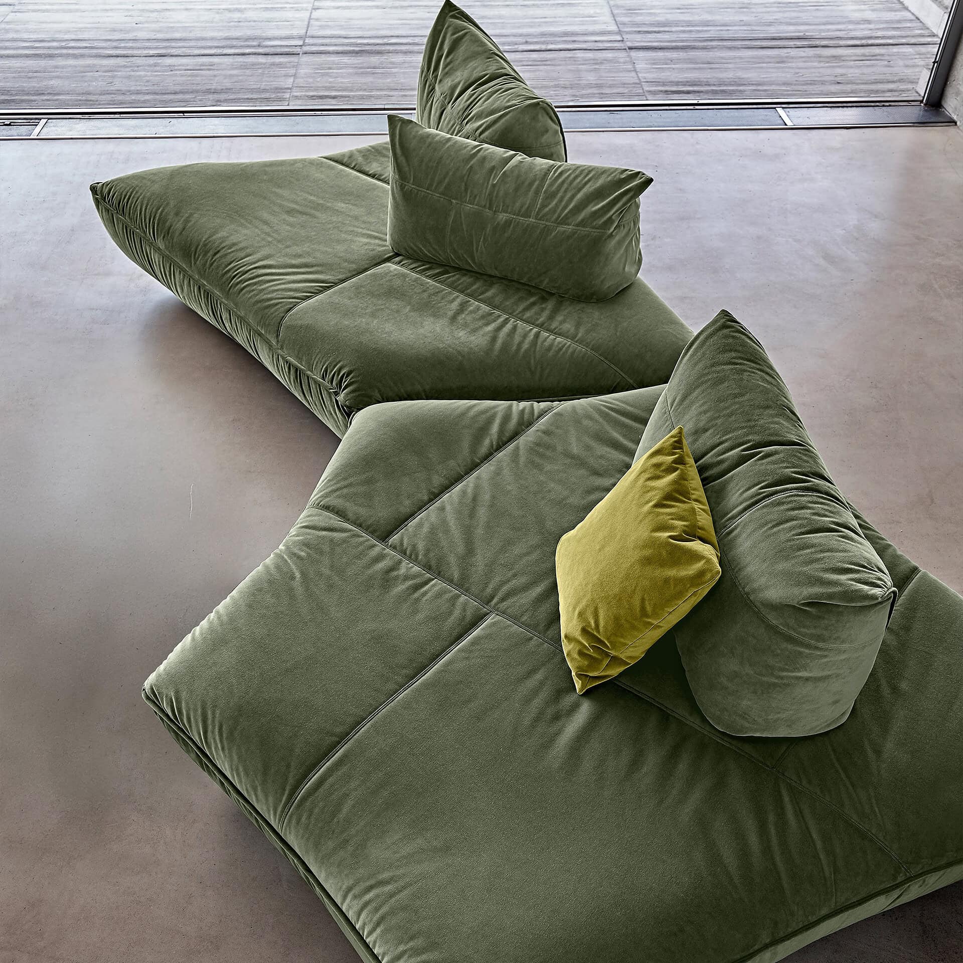 Versatile green Night Fever modular sofa with plush cushions for modern living spaces.