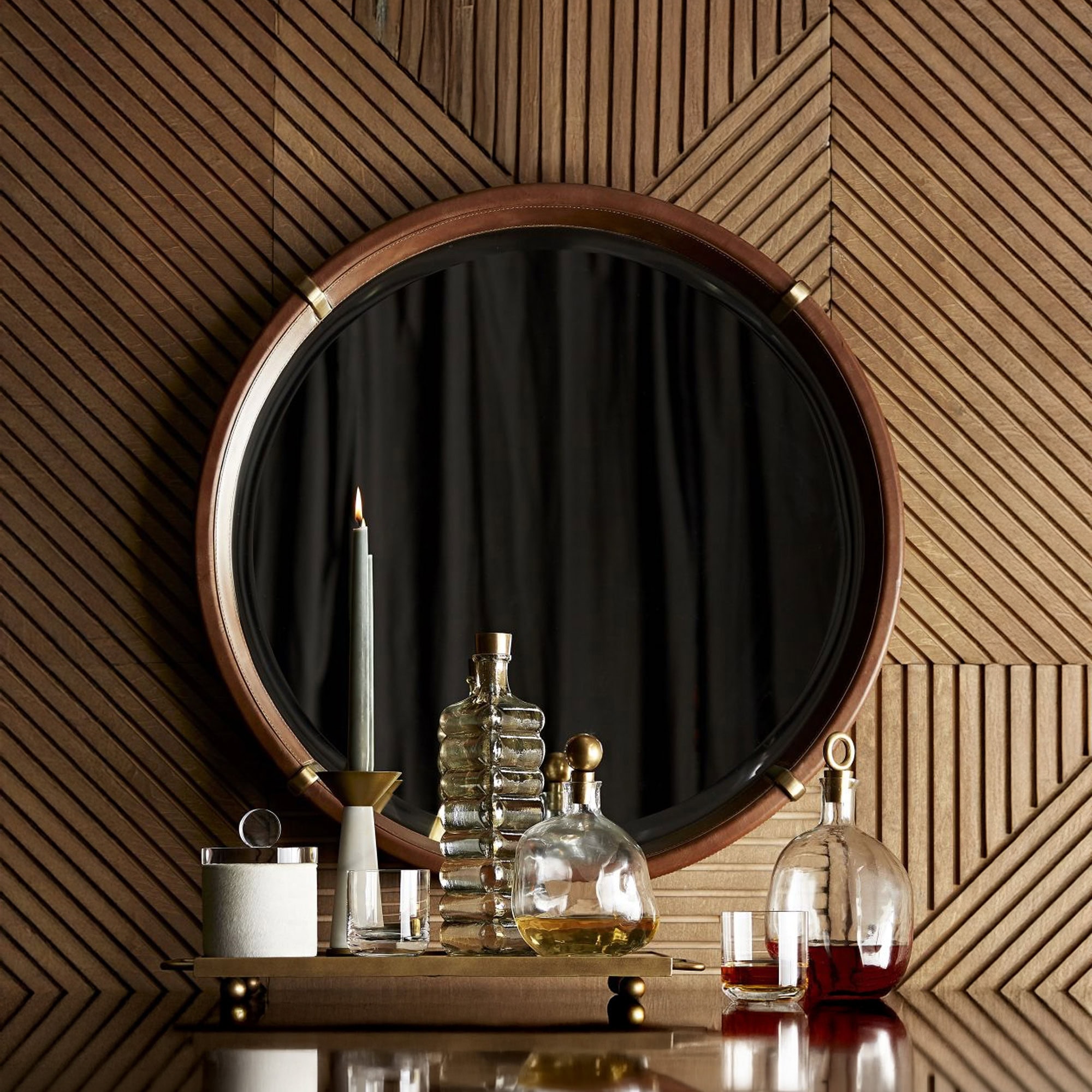 Round Edmund wall mirror with wooden frame and black backdrop, stylish home decor piece.