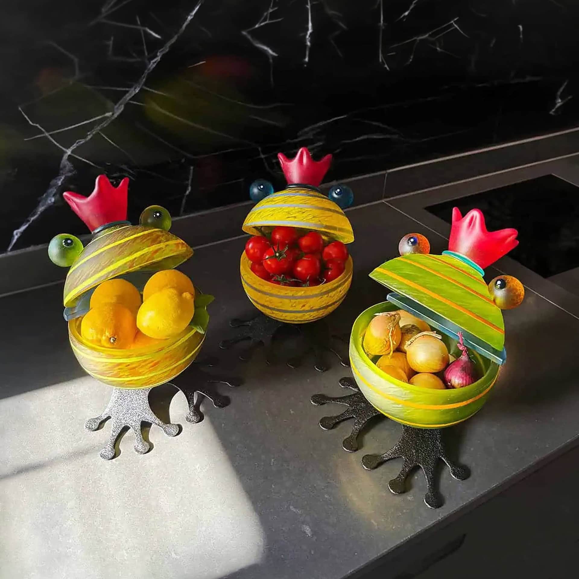Frog-shaped glass bowls with colorful fruits, decorative and functional for kitchen or dining.