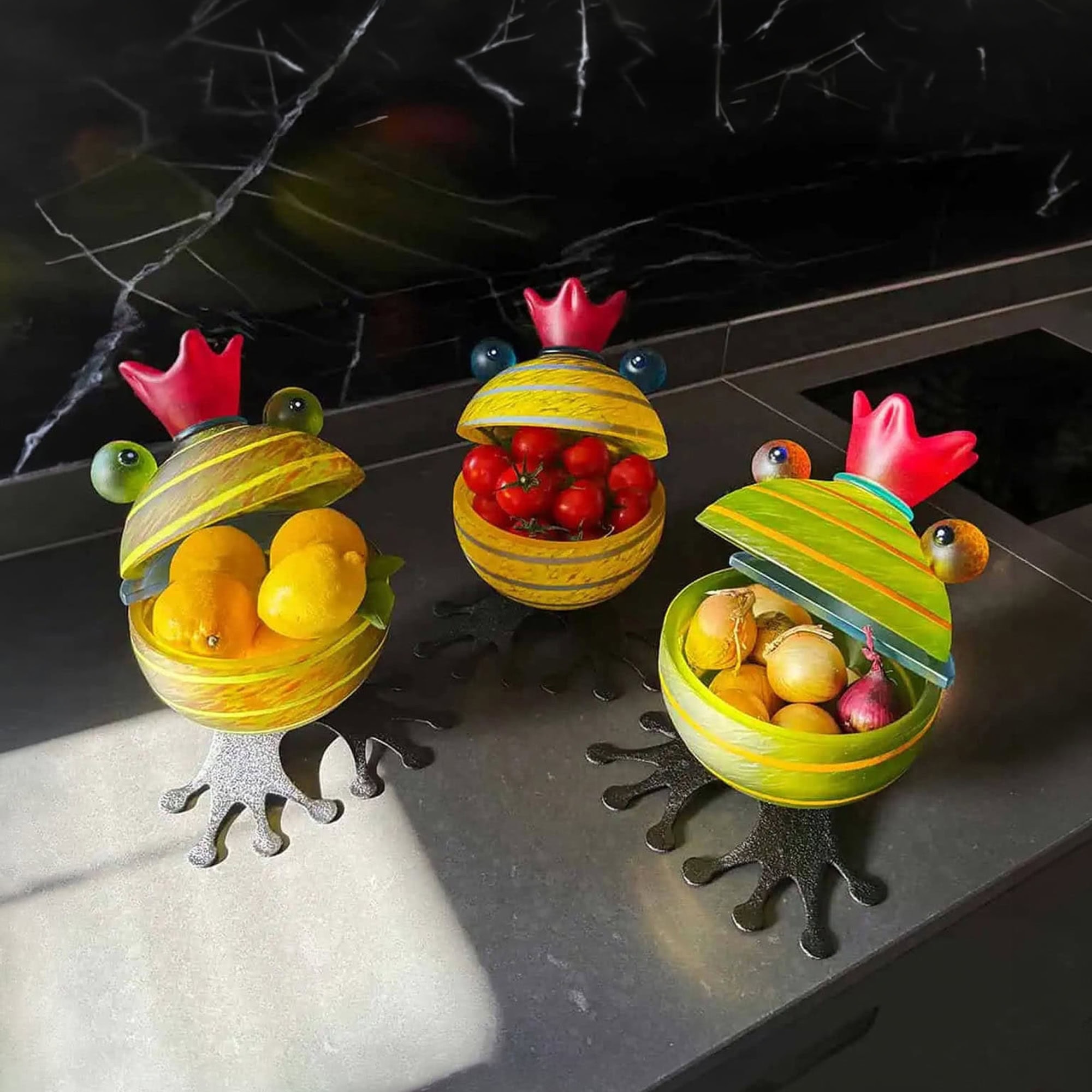 Frog-shaped glass bowls with colorful fruits, decorative and functional for kitchen or dining.