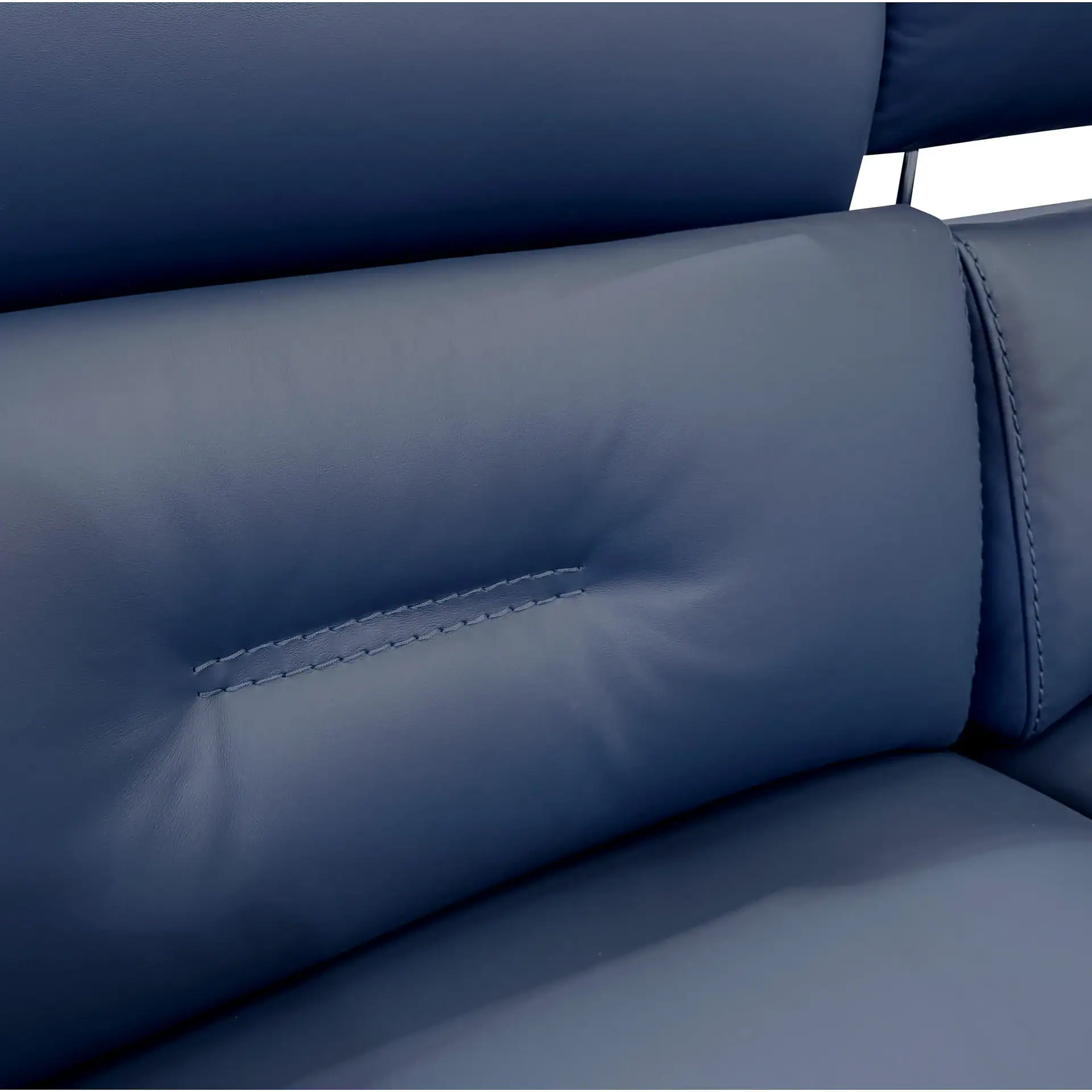 Close-up of dark blue leather furniture, showing padded sections, a stitched seam, and a metal headrest support.
