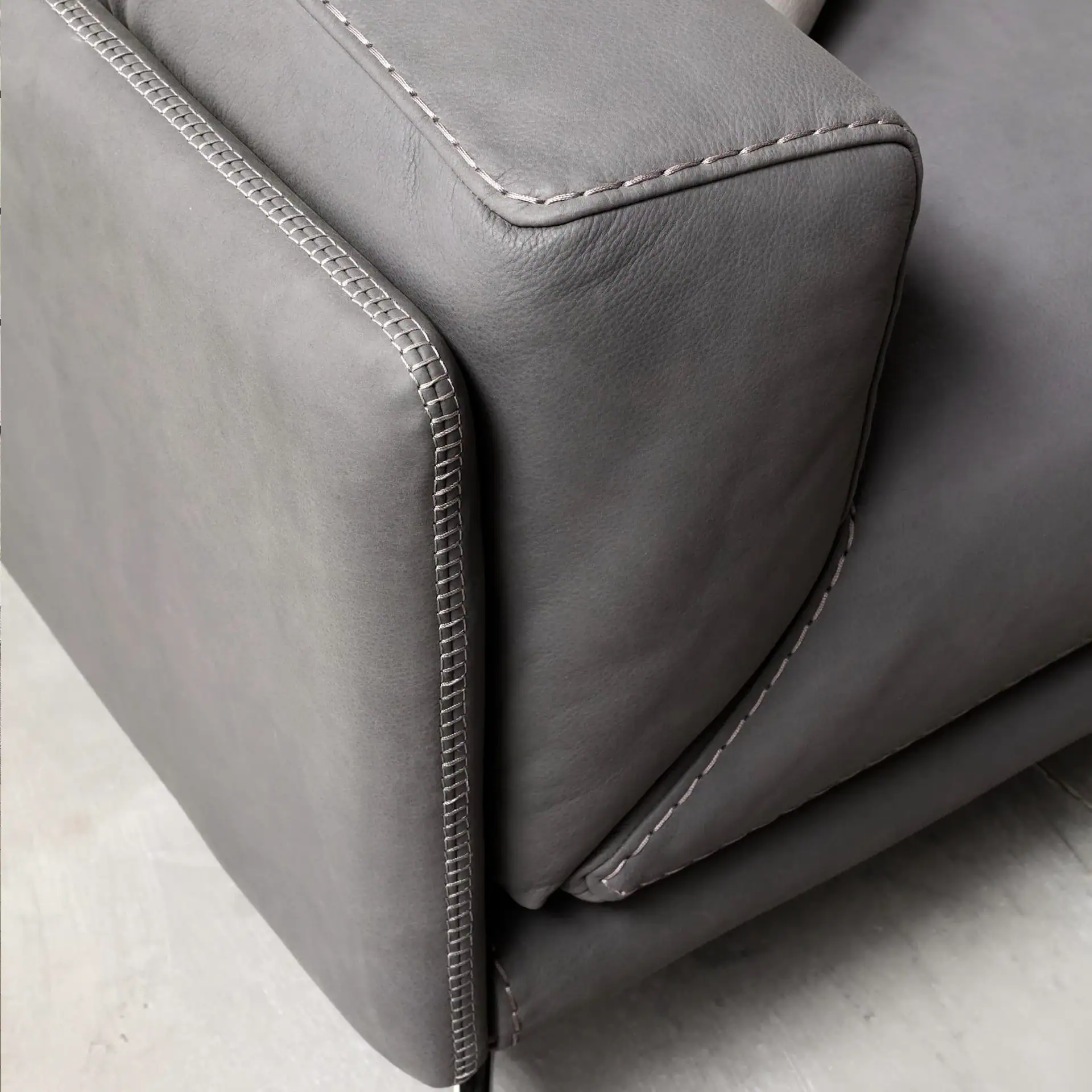 Close-up of Glamour Modular Sectional Sofa armrest with light gray contrast stitching.