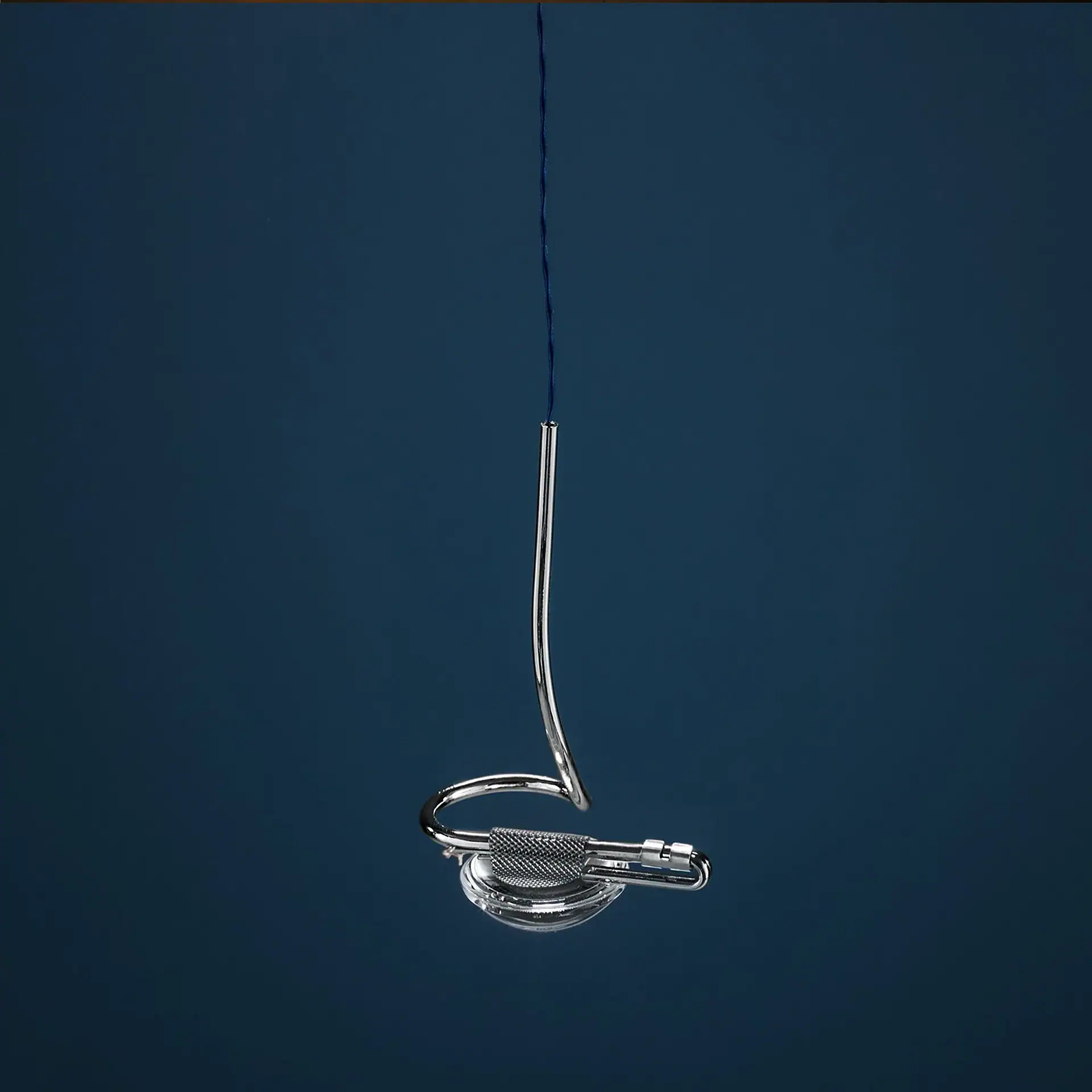 Sklar Furnishings pendant light hanging against a blue wall.