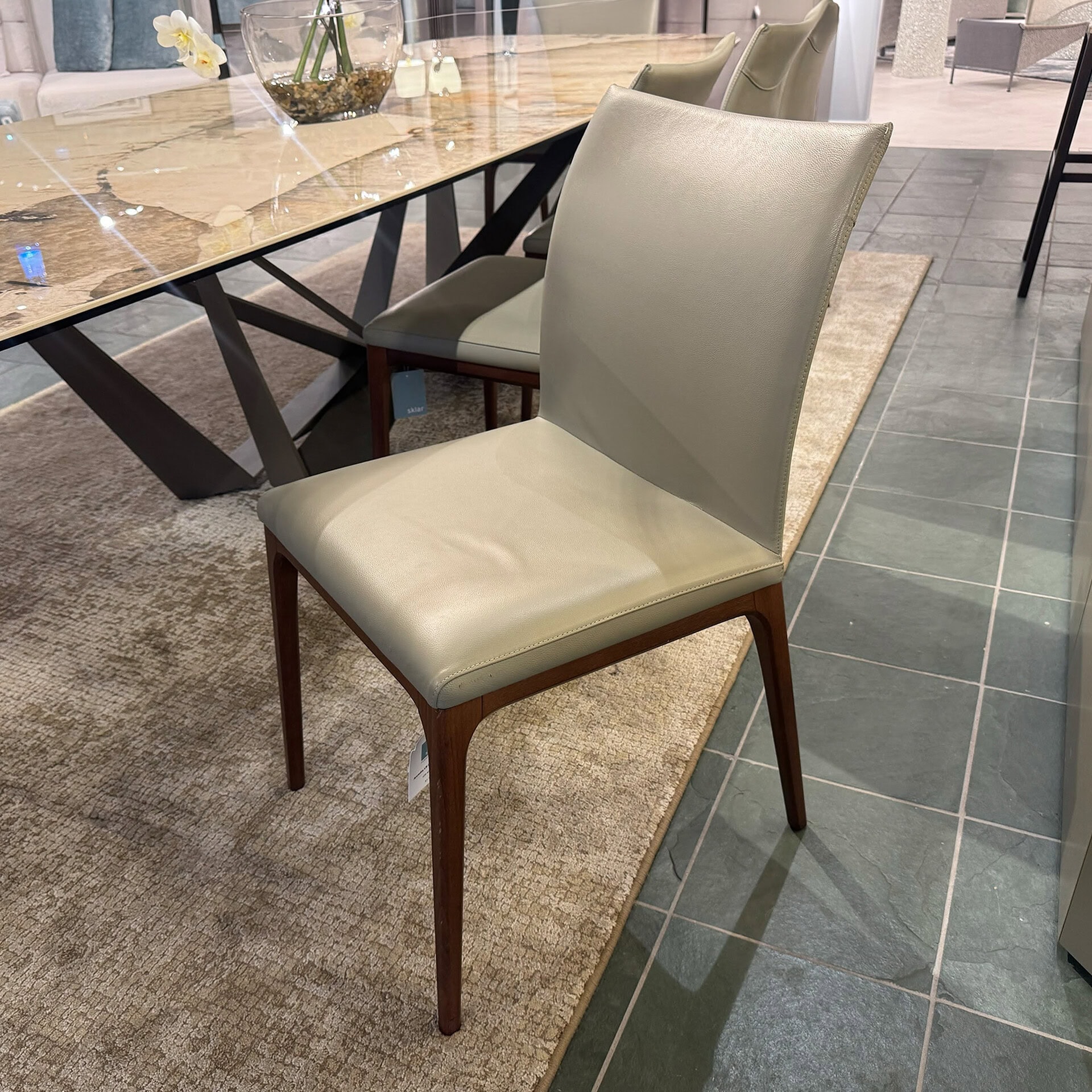Elegant Arcadia upholstered dining chair with wooden legs for modern dining rooms.