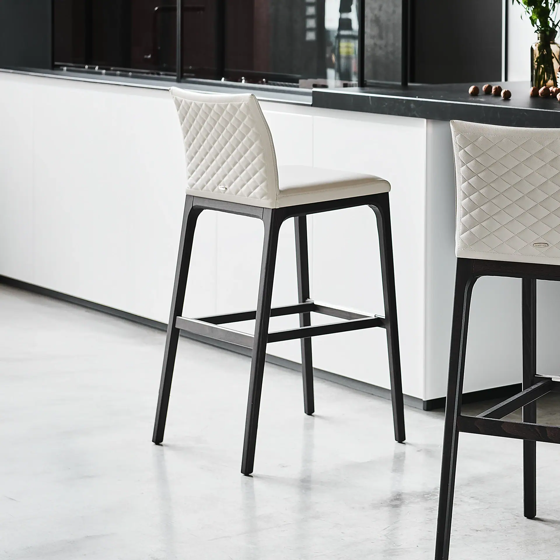 Sklar Furnishings Arcadia upholstered bar stool with quilted backrest.
