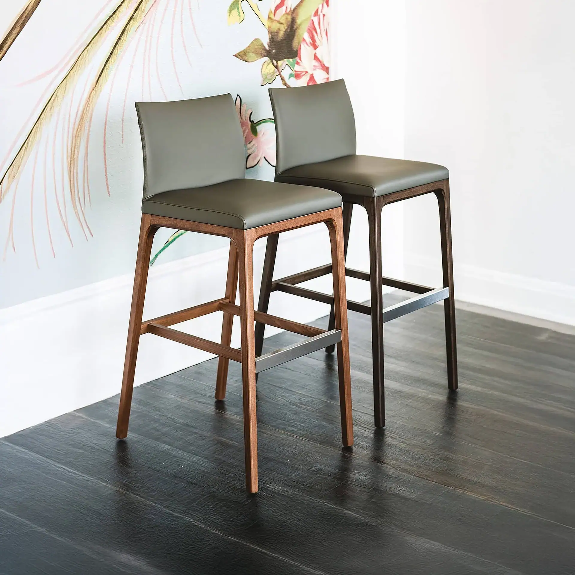 Sklar Furnishings bar and counter stools with upholstered seats and wooden legs.