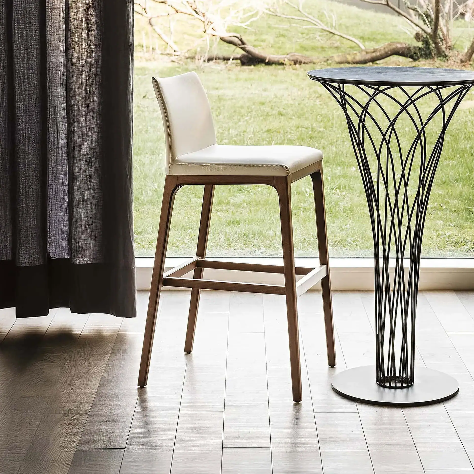 Sklar Furnishings Arcadia upholstered bar stool with white fabric and wooden legs.