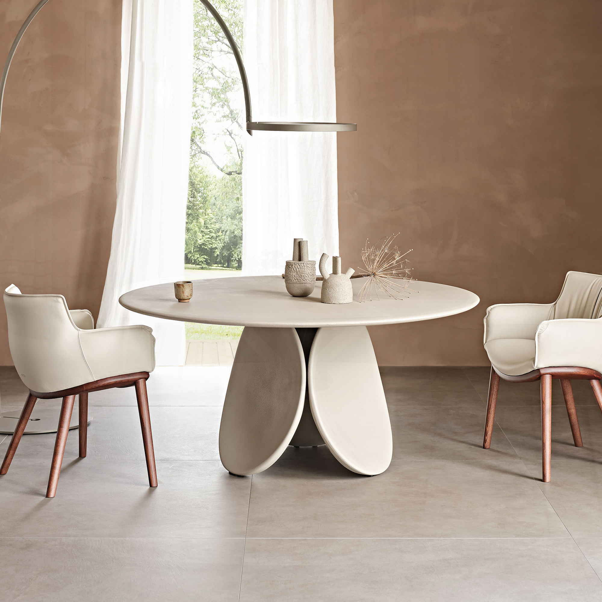 Elegant Maxim Argile round dining table with a modern design. Perfect for contemporary dining spaces.
