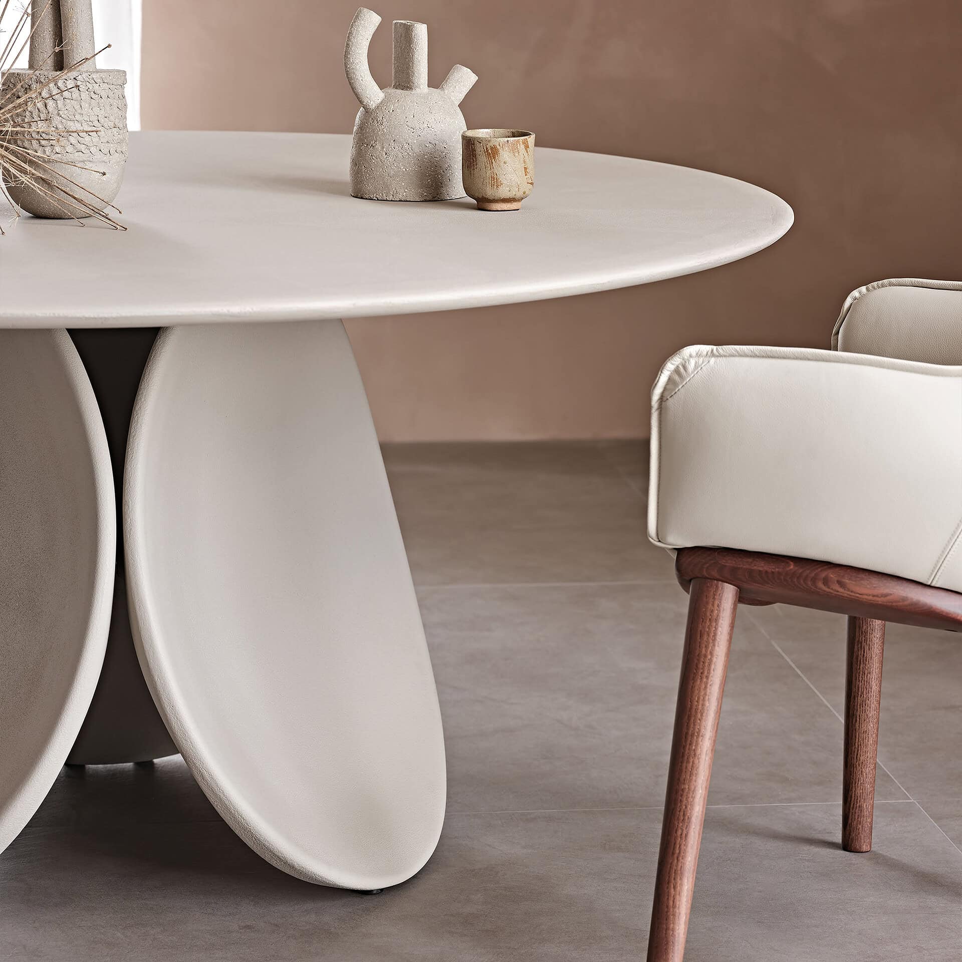 Maxim Argile round dining table with a sleek, contemporary design and smooth white finish.