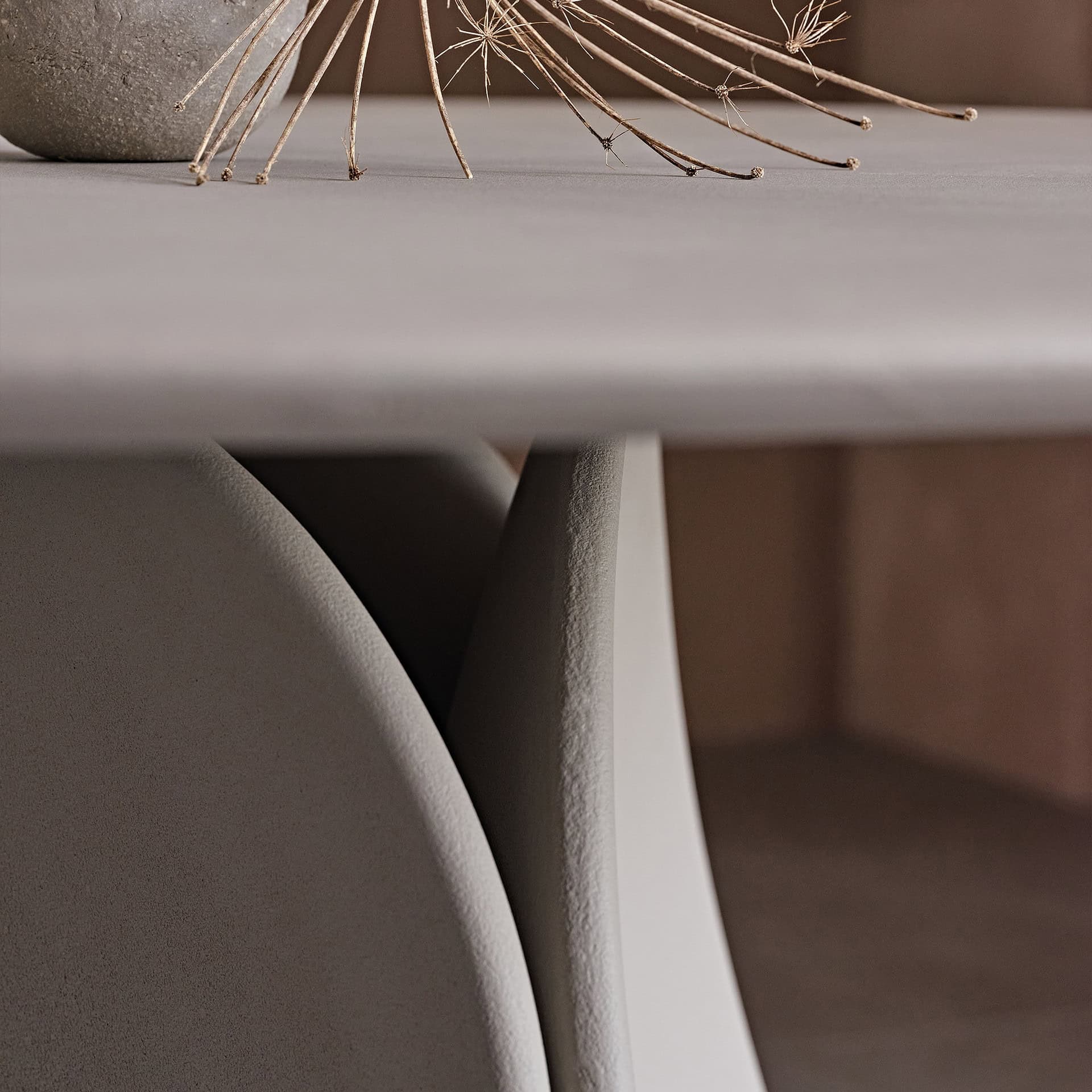 Close-up of a sleek, modern round dining table with a smooth surface and elegant design.