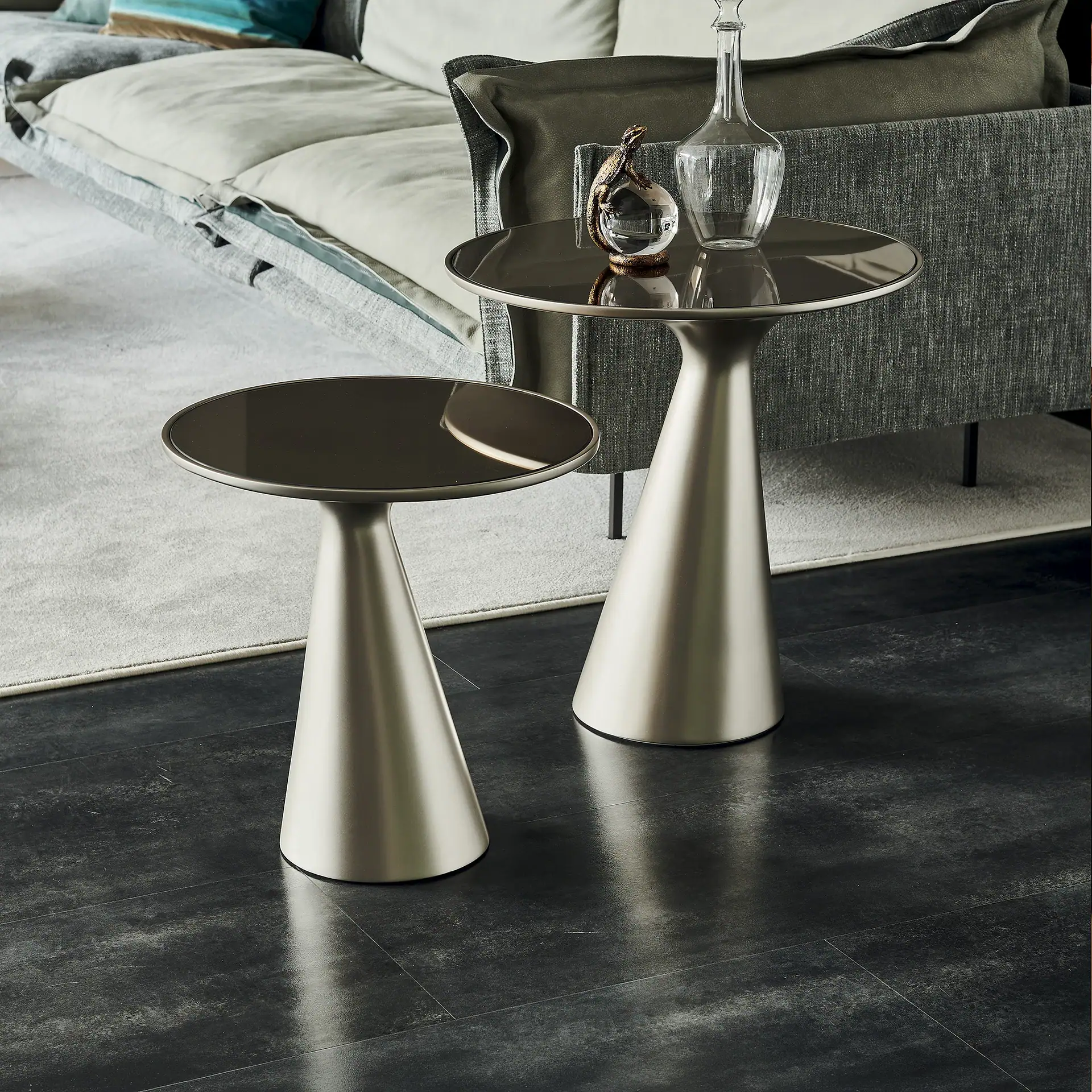 Sklar Furnishings end tables with black tops and metallic bases in living room.
