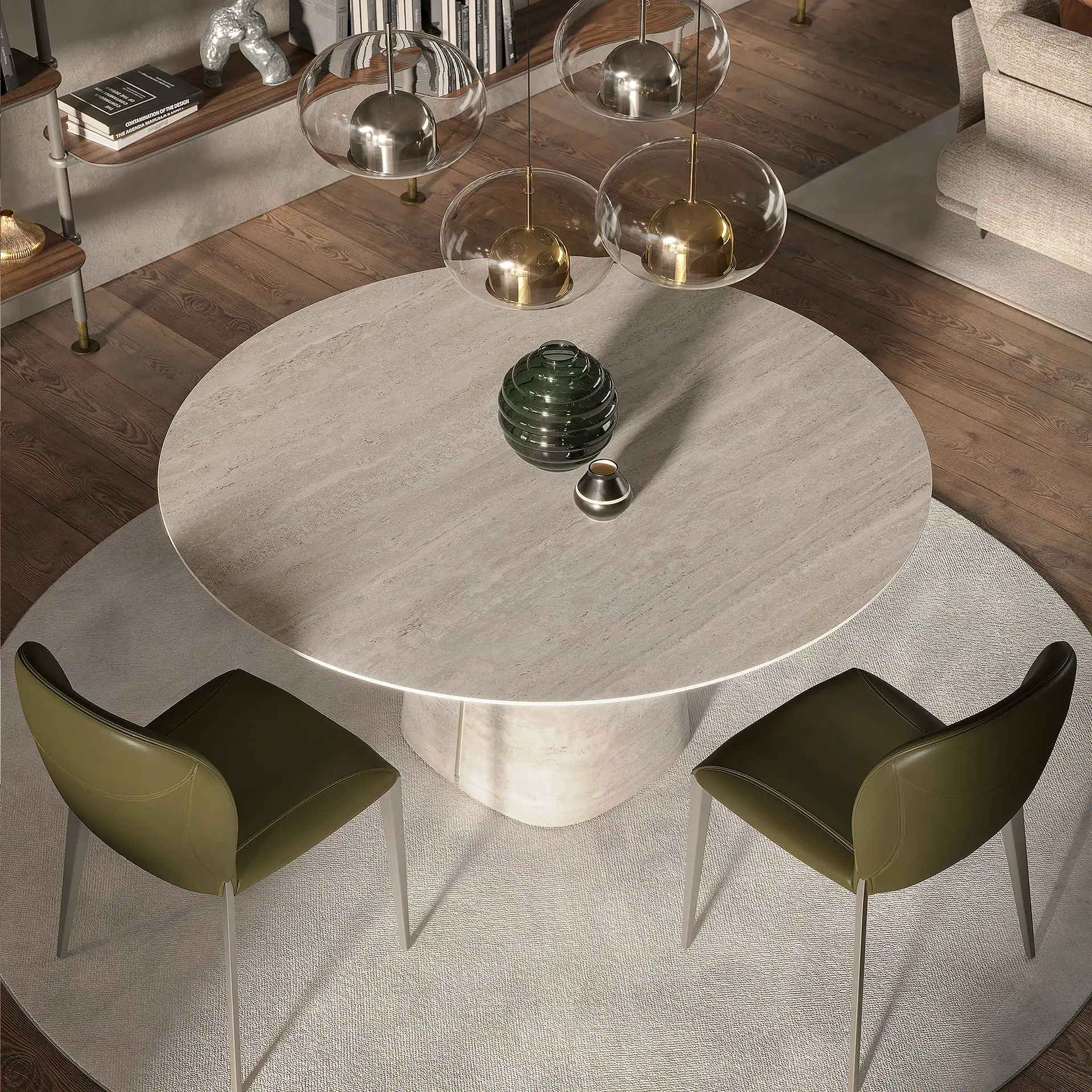 Overhead view of a modern dining area with a round stone table, two olive green chairs, four spherical pendant lights, and a light round rug on a dark wooden floor.