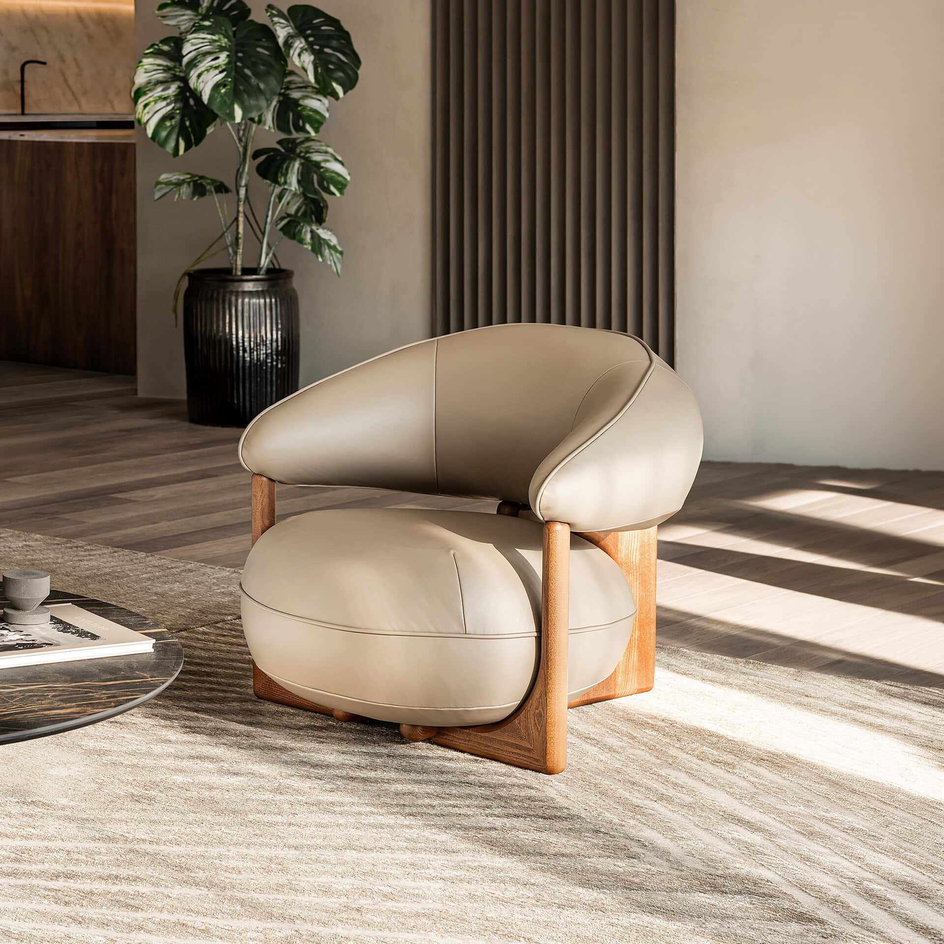 Modern beige leather Ruby Lounge Armchair with wooden frame in stylish living room.