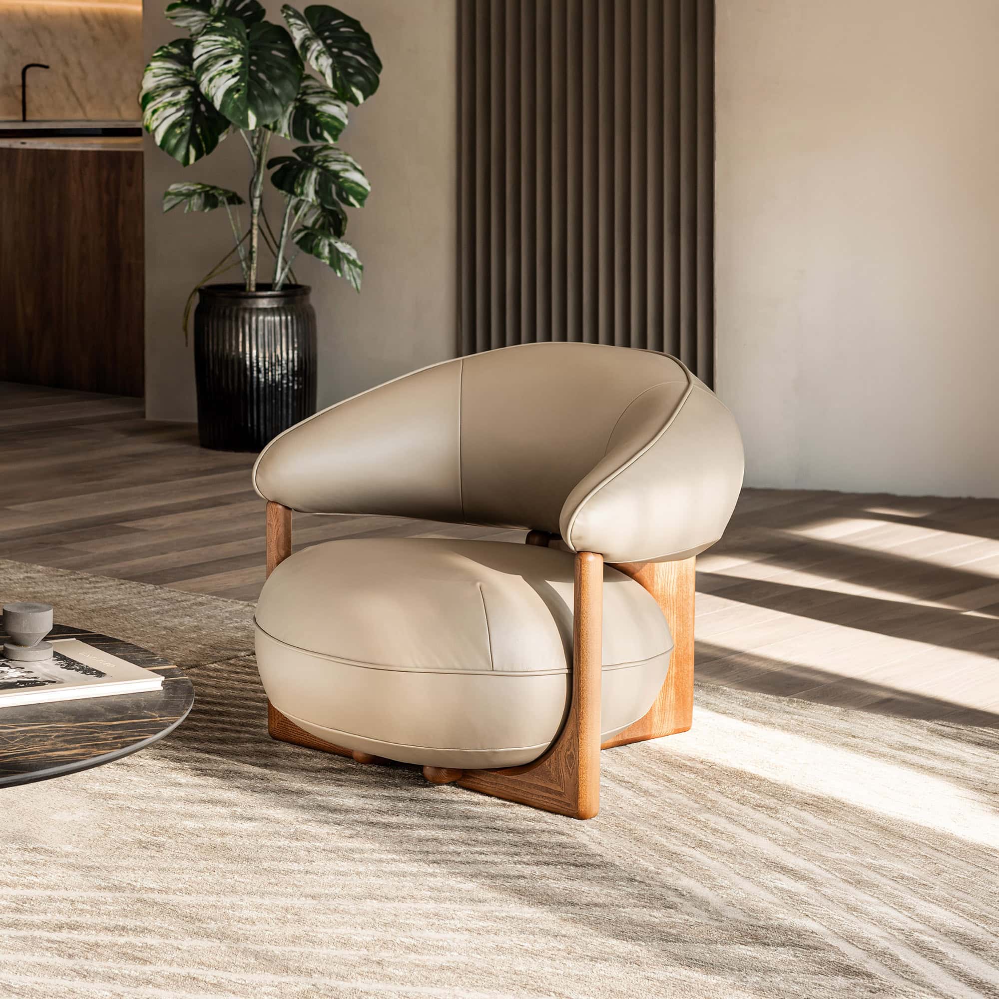 Modern beige leather Ruby Lounge Armchair with wooden frame in stylish living room.