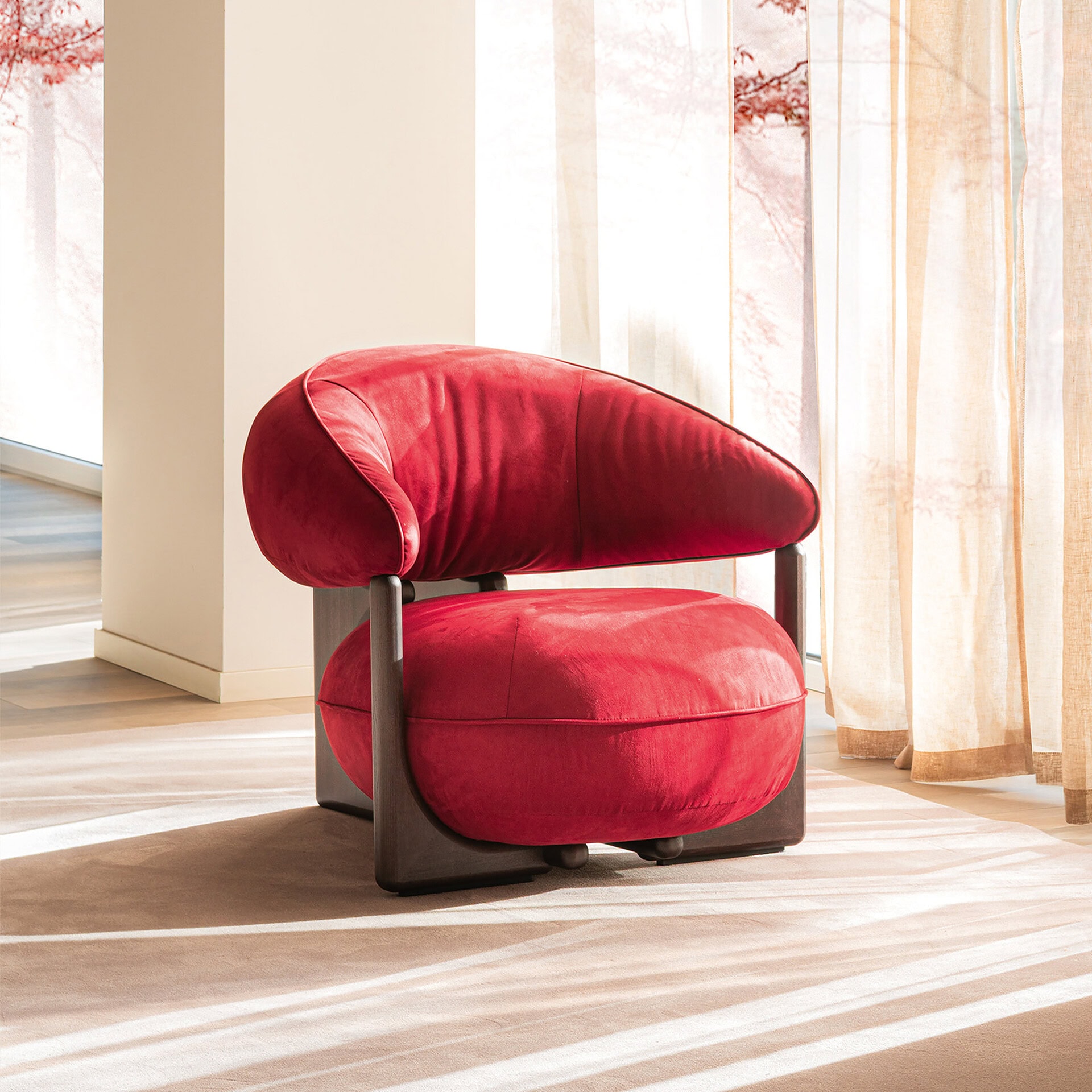 Elegant red velvet lounge armchair for modern living spaces.