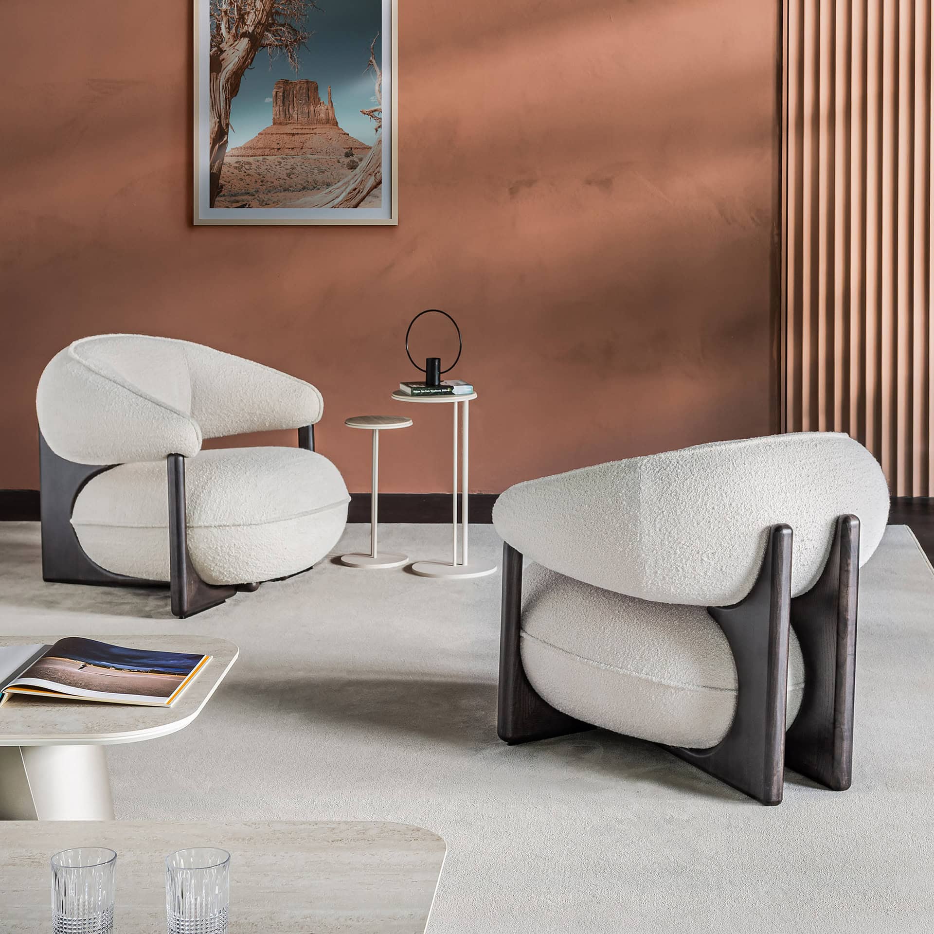 Elegant Ruby Lounge Armchair with plush white upholstery and dark wood accents.