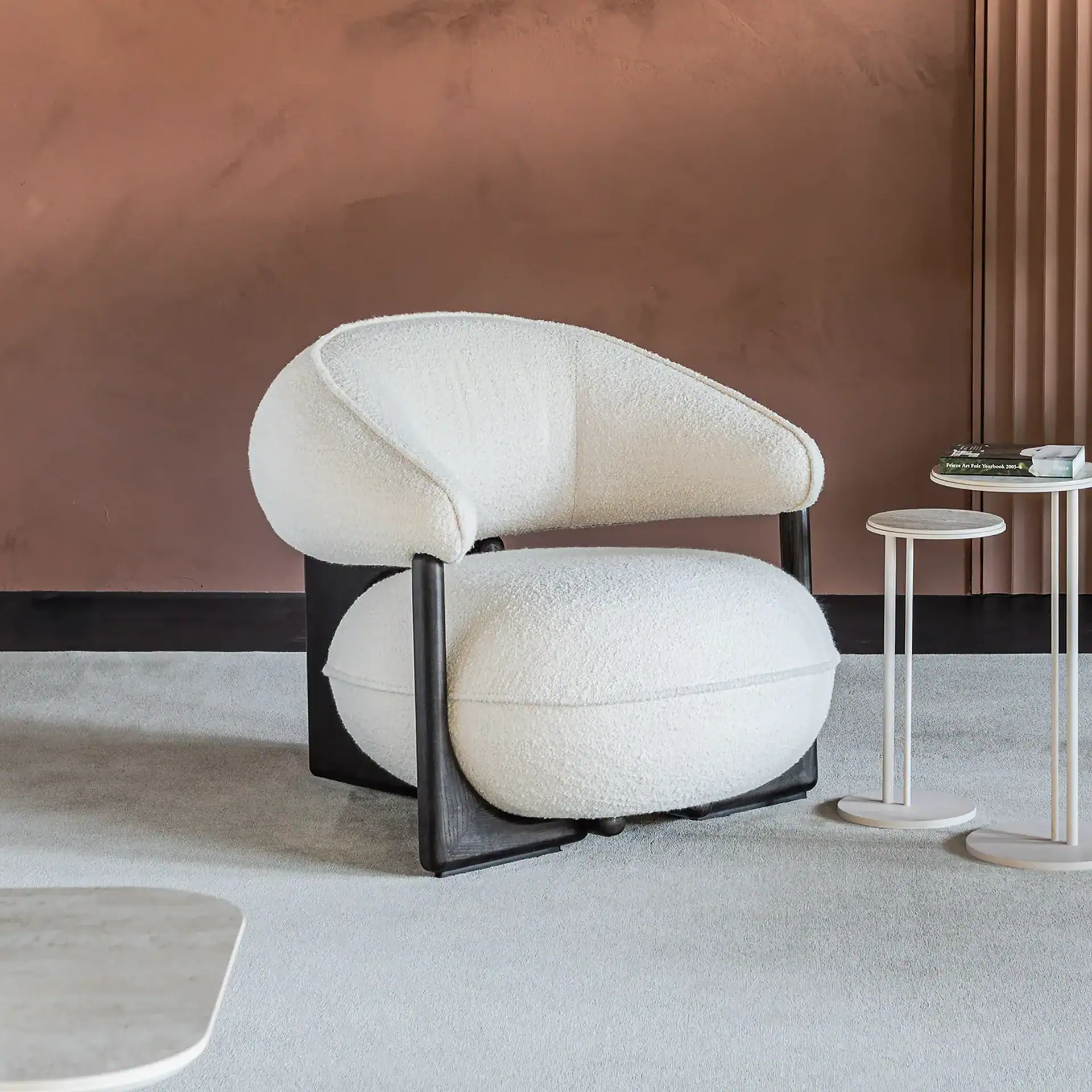 Modern beige leather Ruby Lounge Armchair with wooden frame in stylish living room.