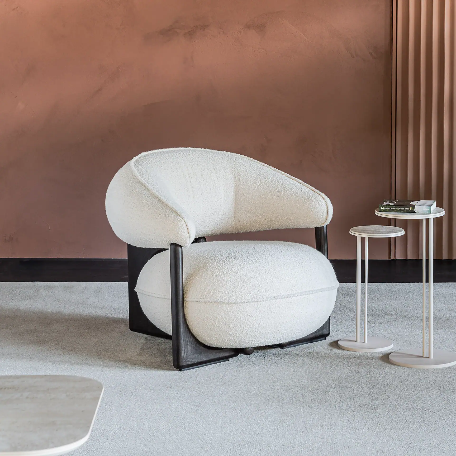 Modern beige leather Ruby Lounge Armchair with wooden frame in stylish living room.