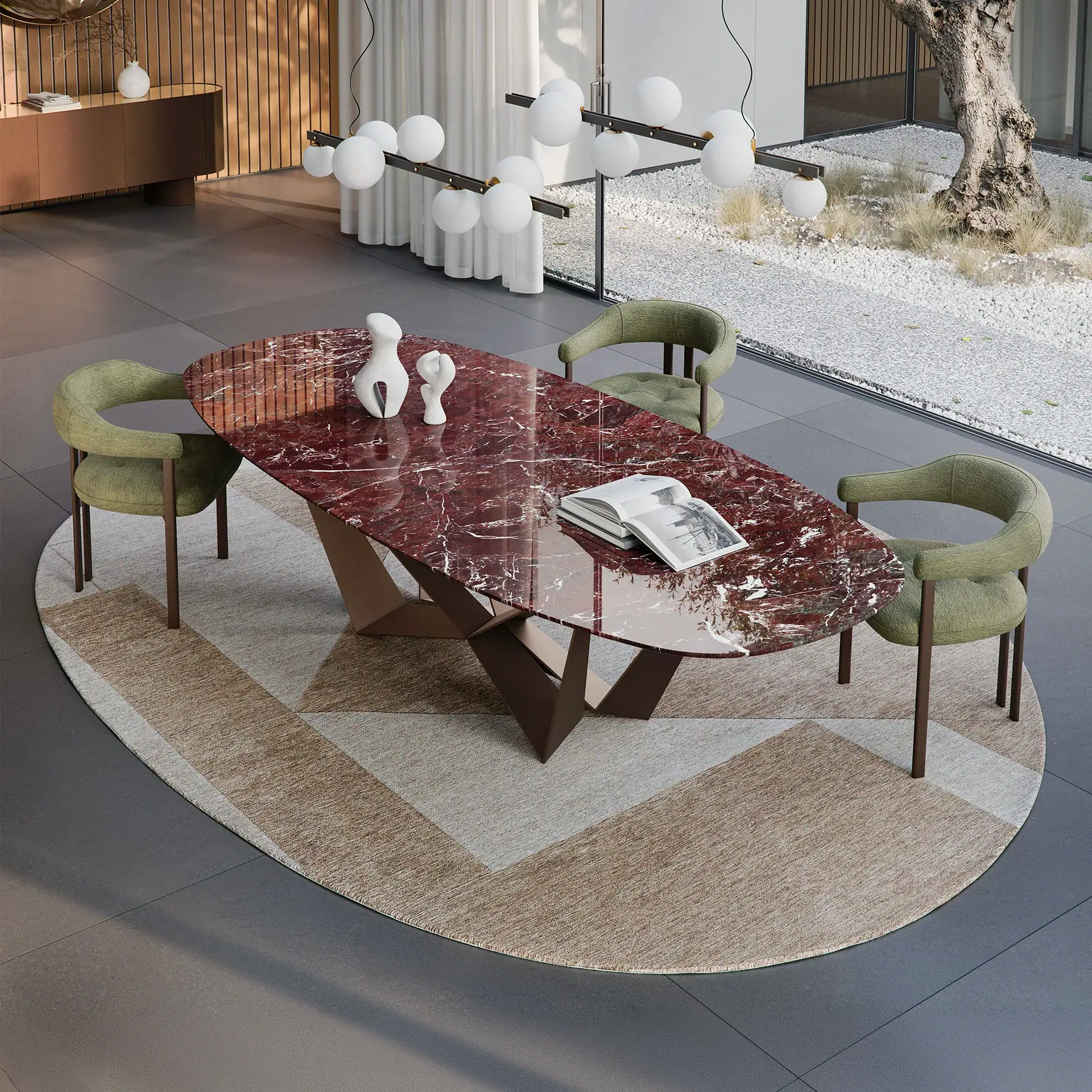 A modern dining room with an oval red marble table, four olive green chairs, and a geometric rug. Large windows overlook a white gravel garden with a tree.