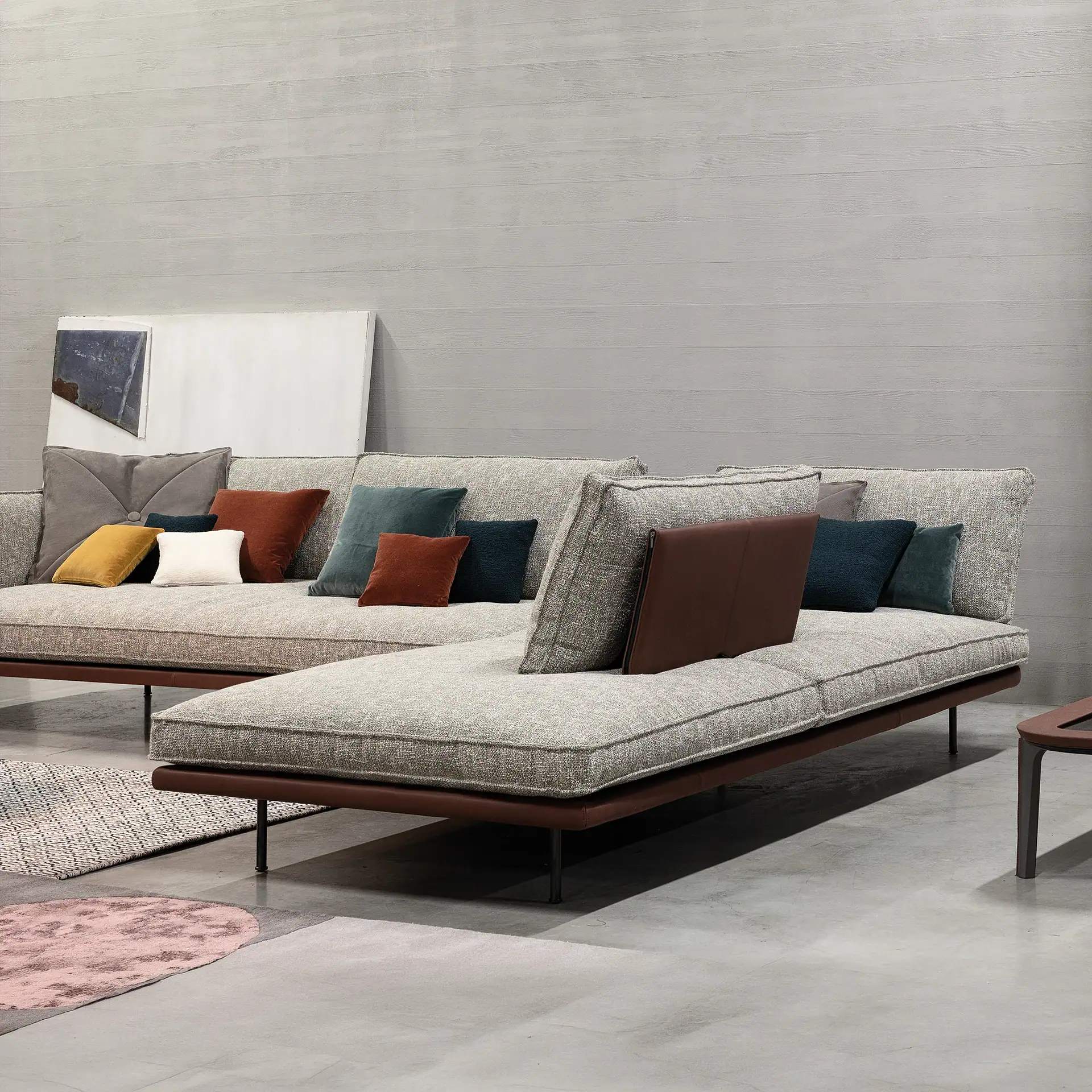 Sklar Furnishings sectional sofa with colorful cushions in modern room.
