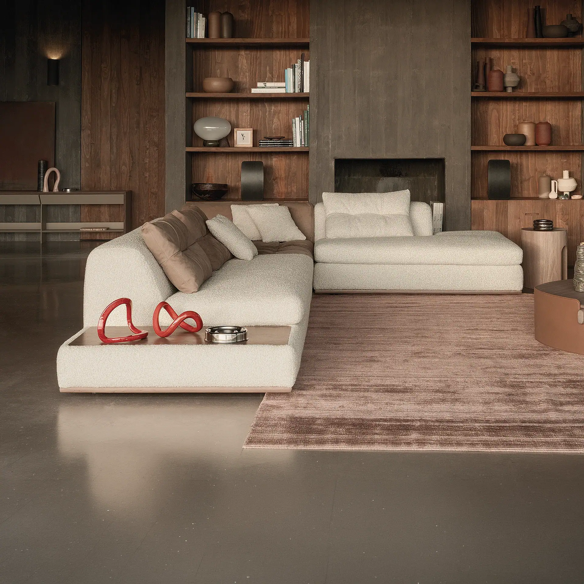 A modern living room with an L-shaped off-white bouclé sofa, a brown textured rug, and wooden built-in shelves filled with books and decorative objects.