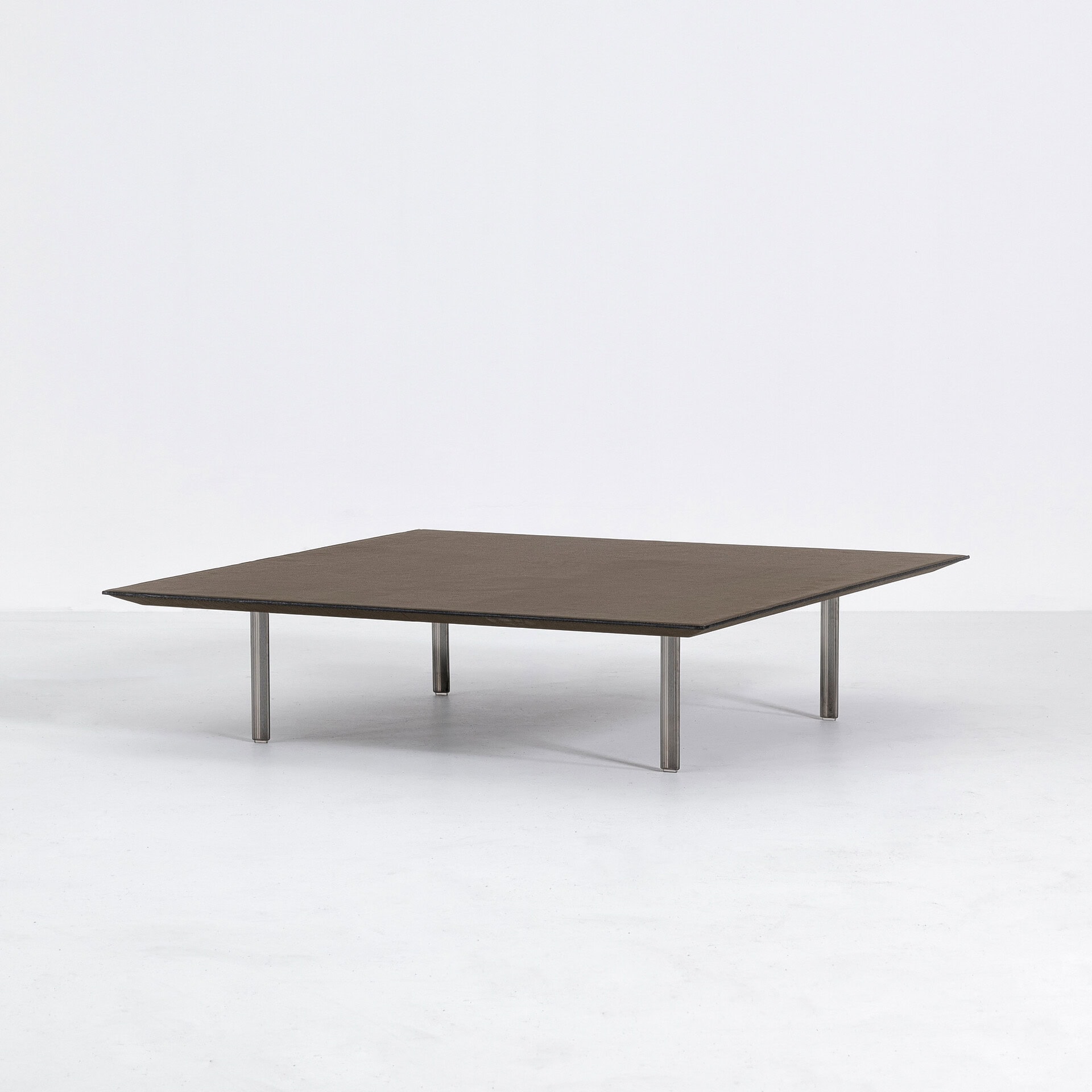 Leather coffee table with sleek metal legs for modern living rooms.