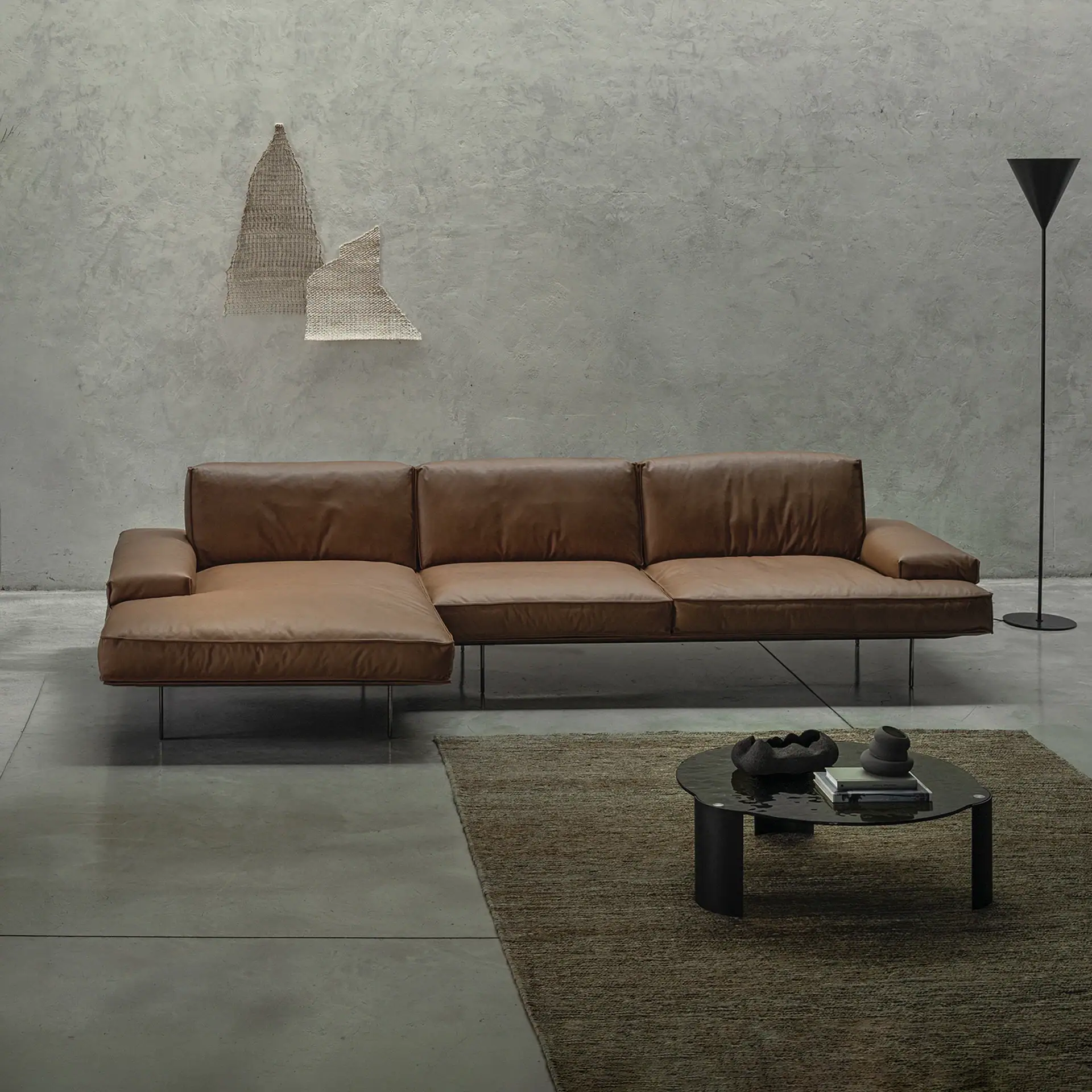 Modern leather sofa in a minimalist living room setting.