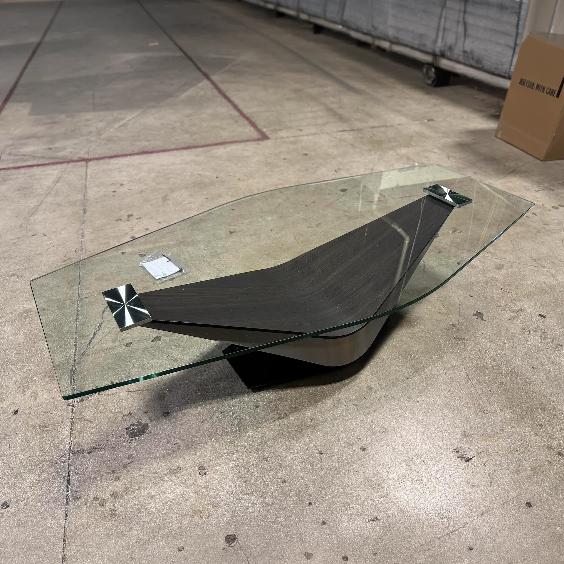 Sklar Furnishings Victor Cocktail Table with glass top in a showroom.
