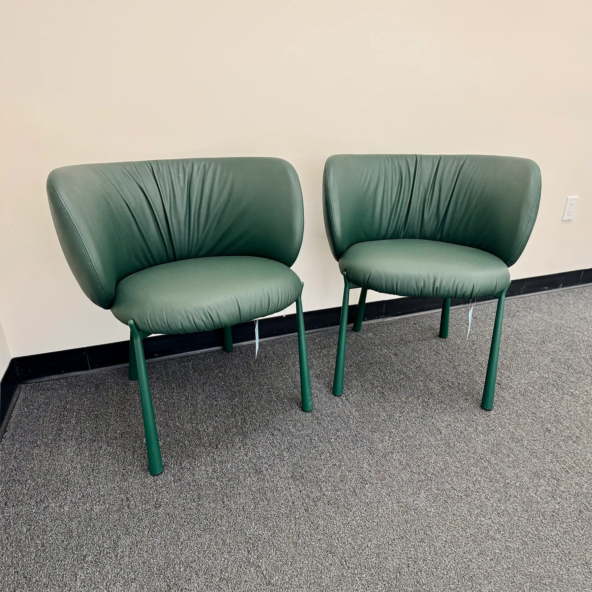 Pair of green Midj Mys dining chairs with curved backrests.