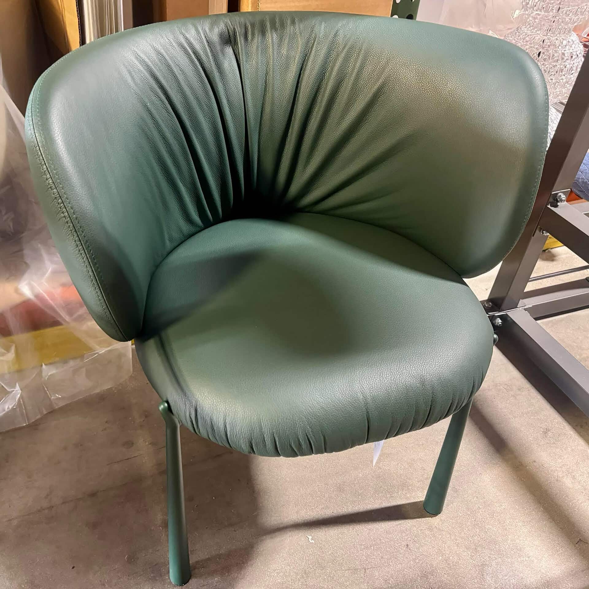 Elegant green dining chair with plush upholstery.