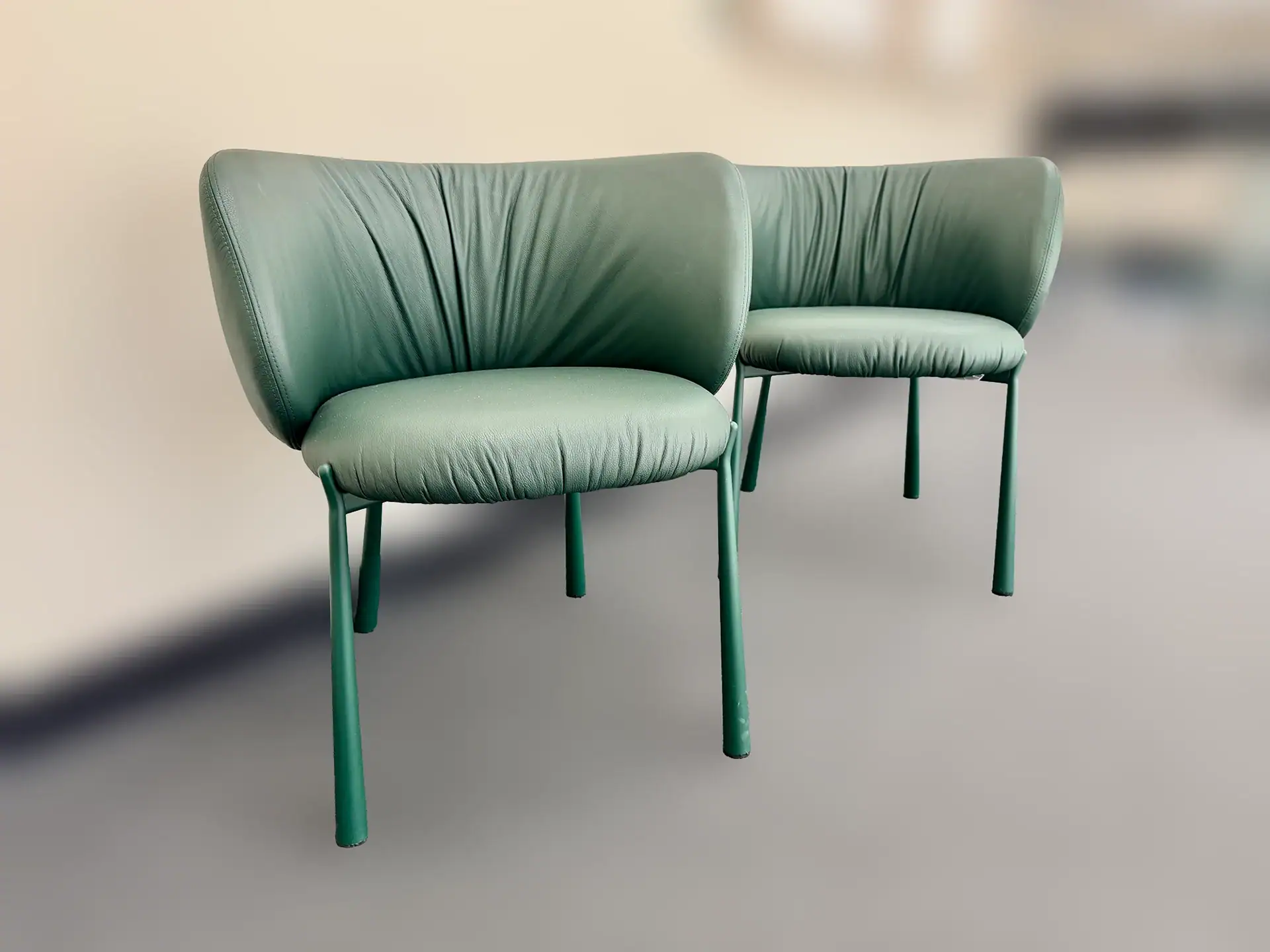 Elegant green dining chairs with curved backrests and slender legs.