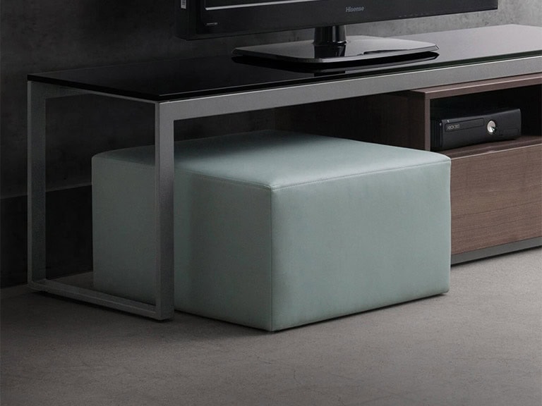 Upholstered ottoman in soft mint green, perfect as a versatile accent piece for modern living spaces.