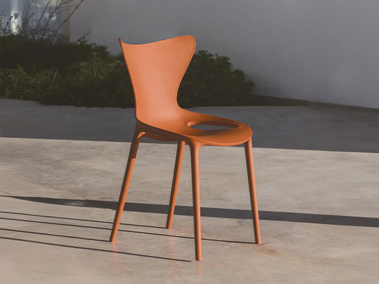 Vondom Love outdoor dining chair in orange, perfect for modern outdoor spaces.