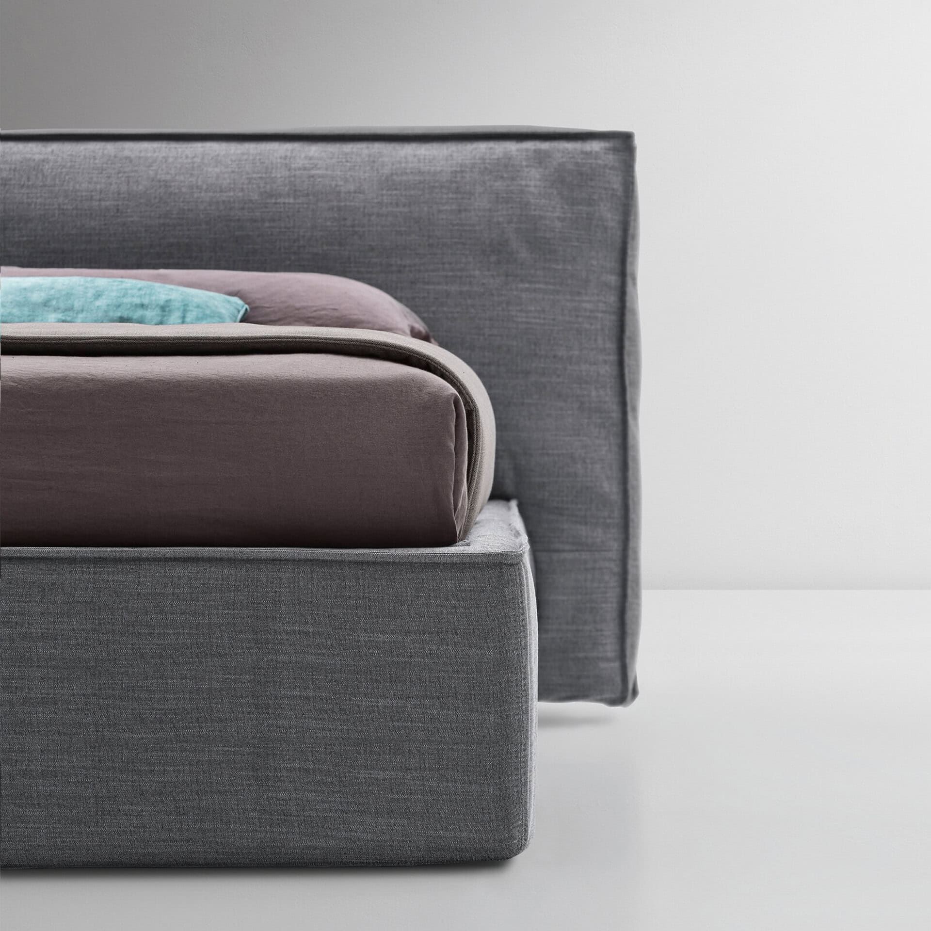 Upholstered platform bed with sleek gray fabric, modern design, and comfortable headboard. Perfect f.