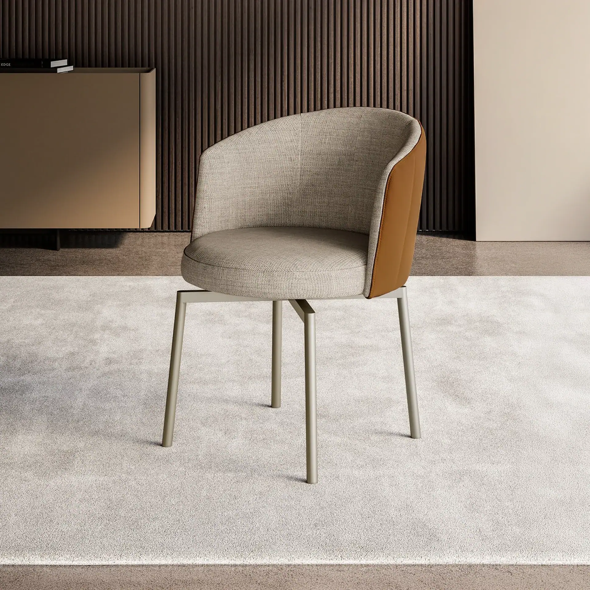 A modern chair with a light beige fabric seat and tan leather back, on a light grey rug. A dark slatted wall and beige cabinet are in the background.