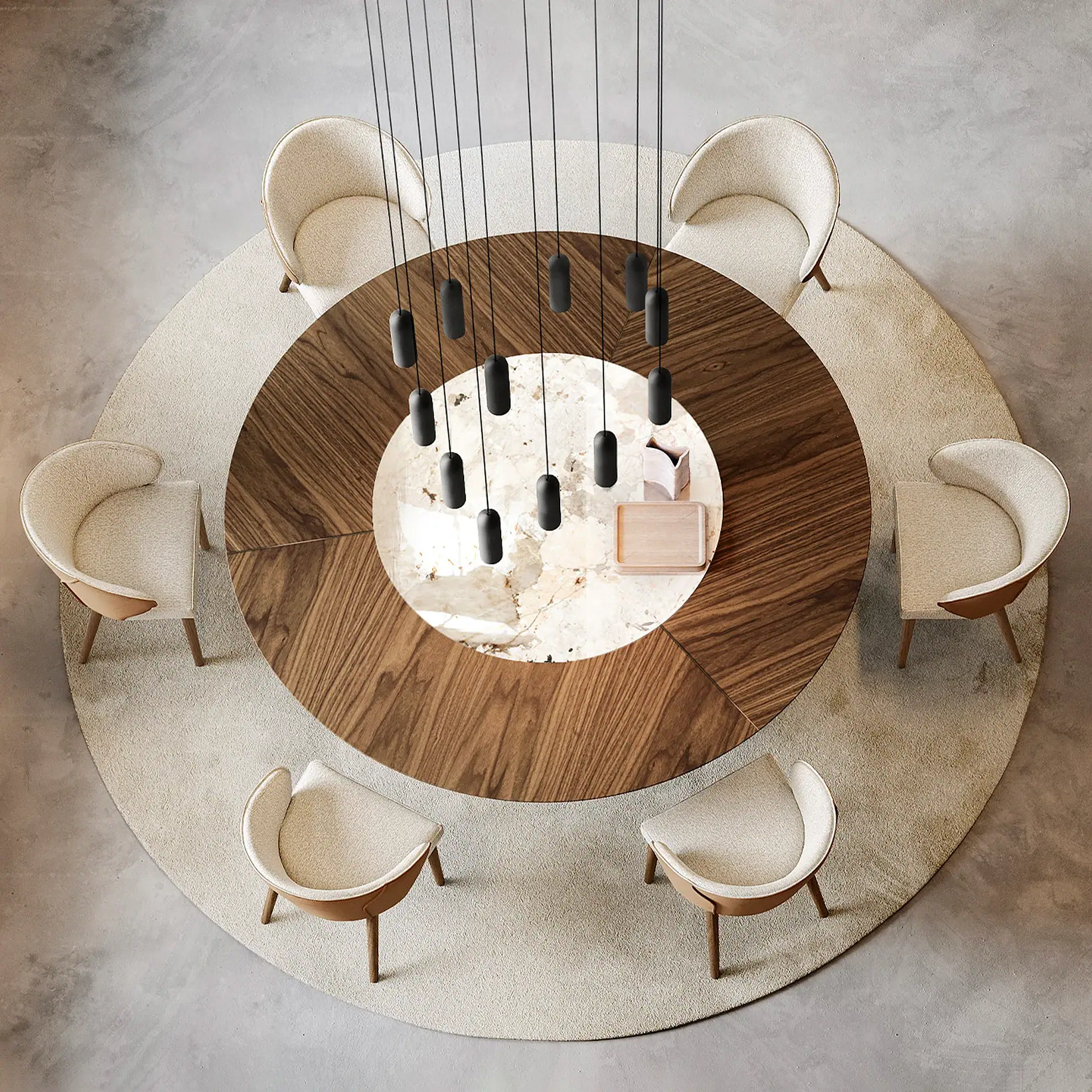 Overhead view of a modern dining room with a circular wood and marble table, six cream chairs, a round rug, and a multi-pendant chandelier.