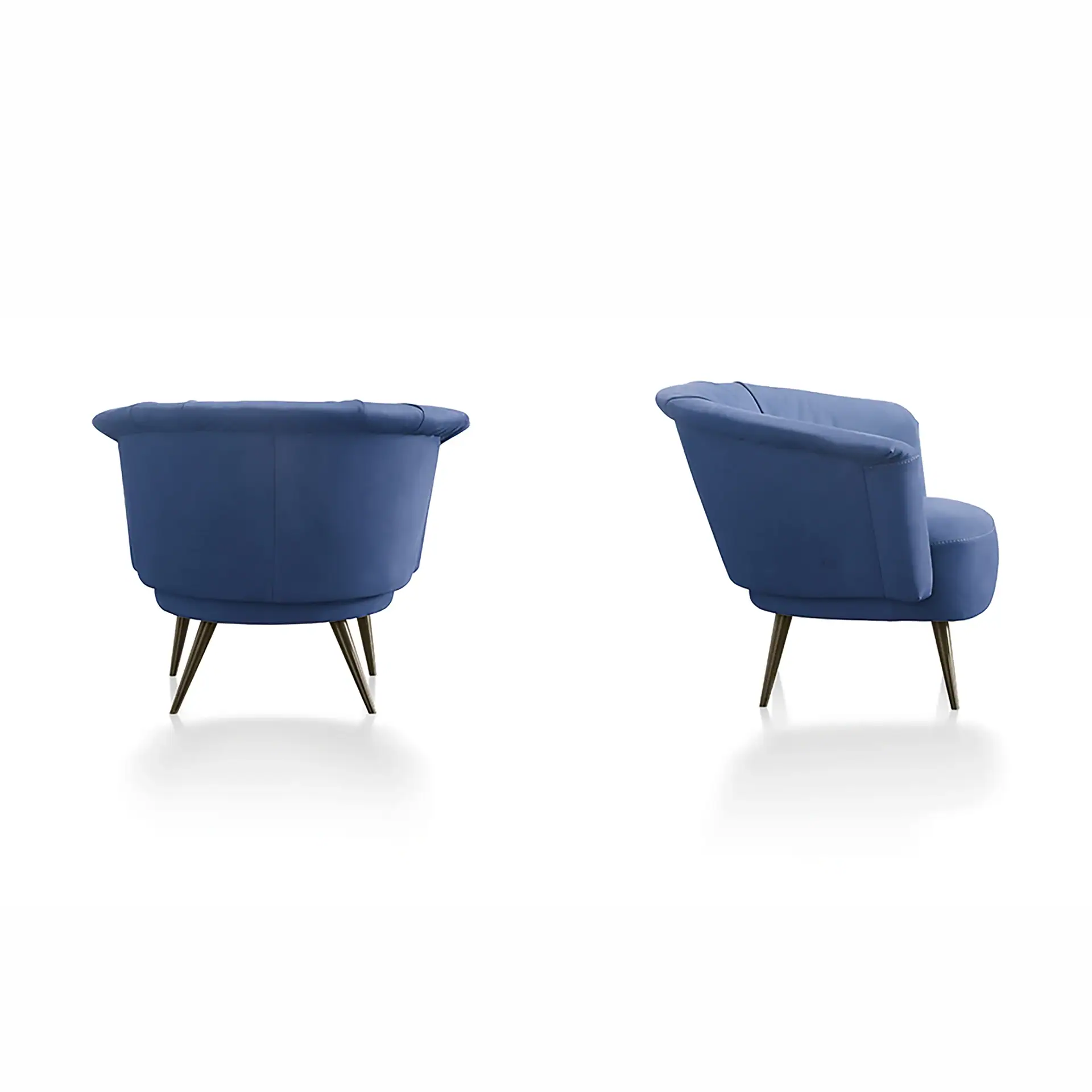 Two blue armchairs, one from the rear-left showing a curved back and tufting, and one from the front-right showing the seat and armrests. Both have dark tapered legs.