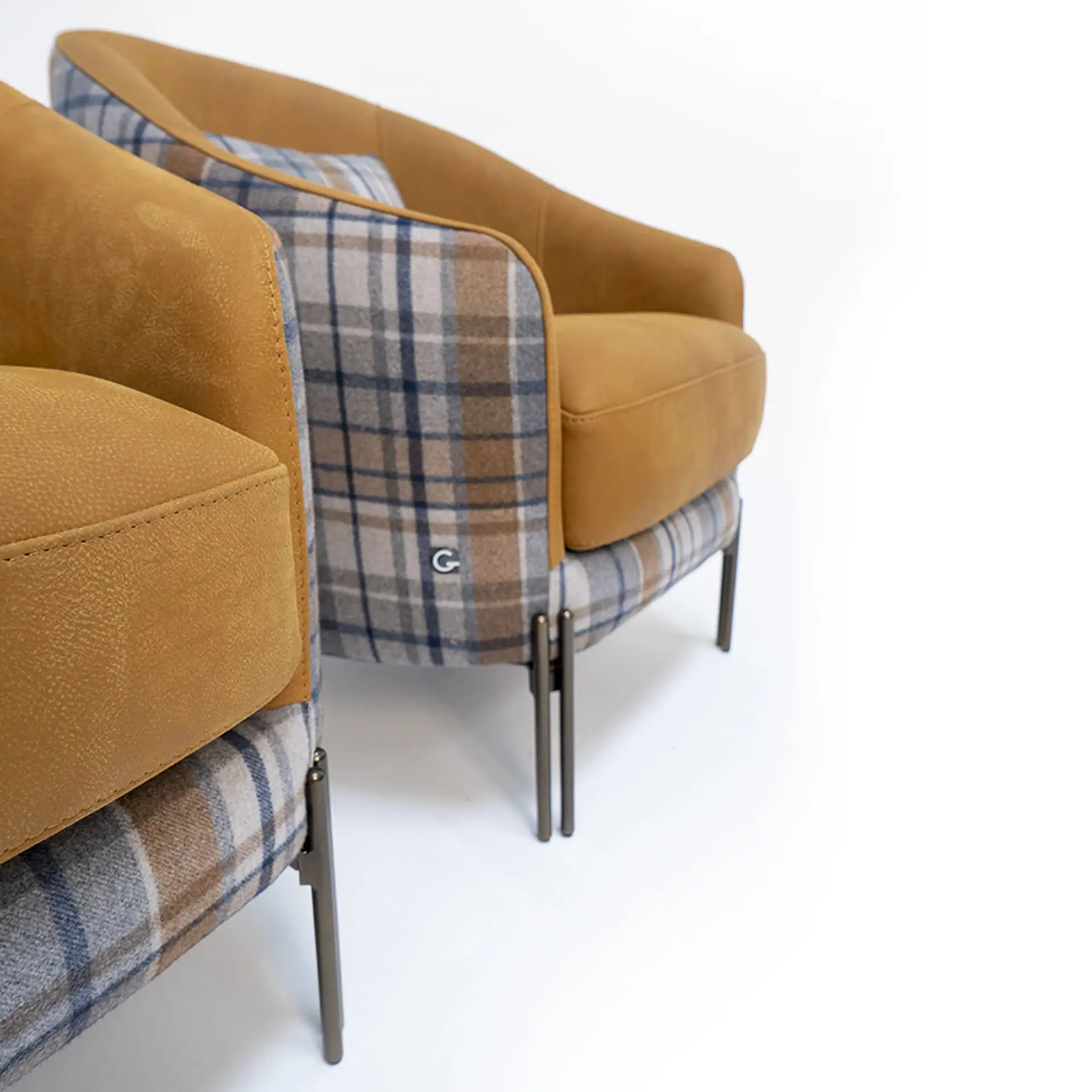 Two armchairs with mustard yellow and blue-brown plaid upholstery on dark metal legs, against a white background.
