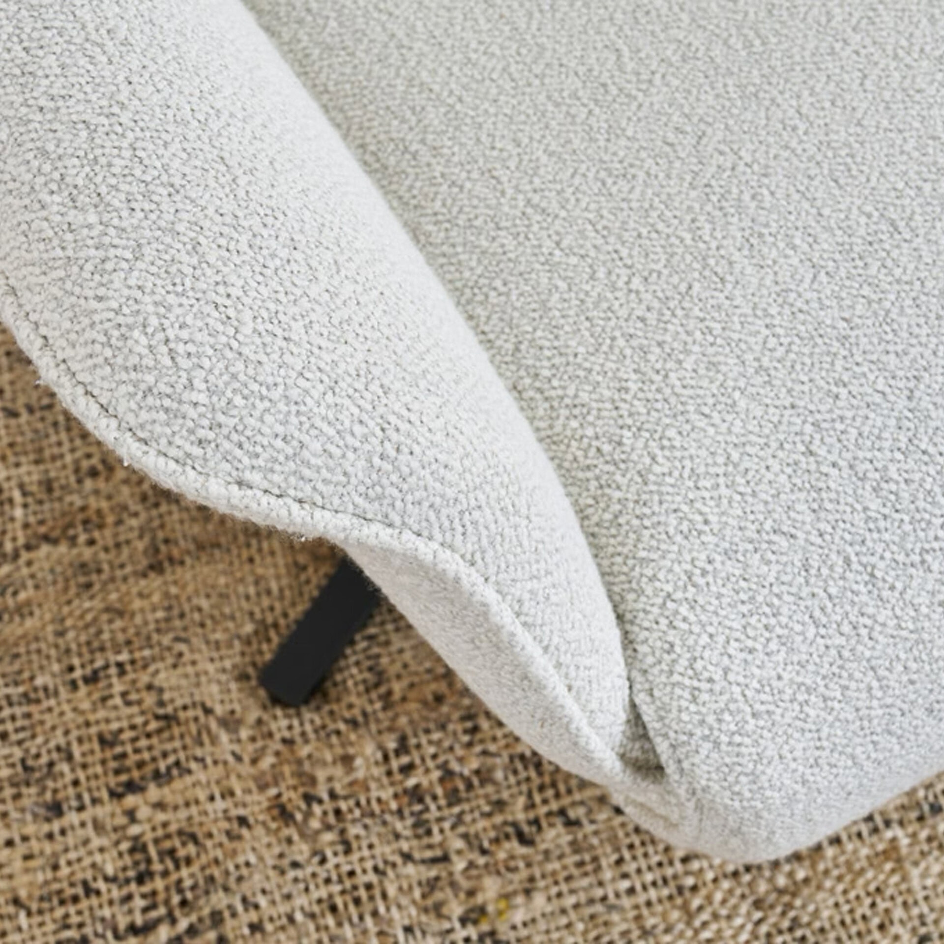 Recliner chair with textured light fabric, perfect for comfort and style.