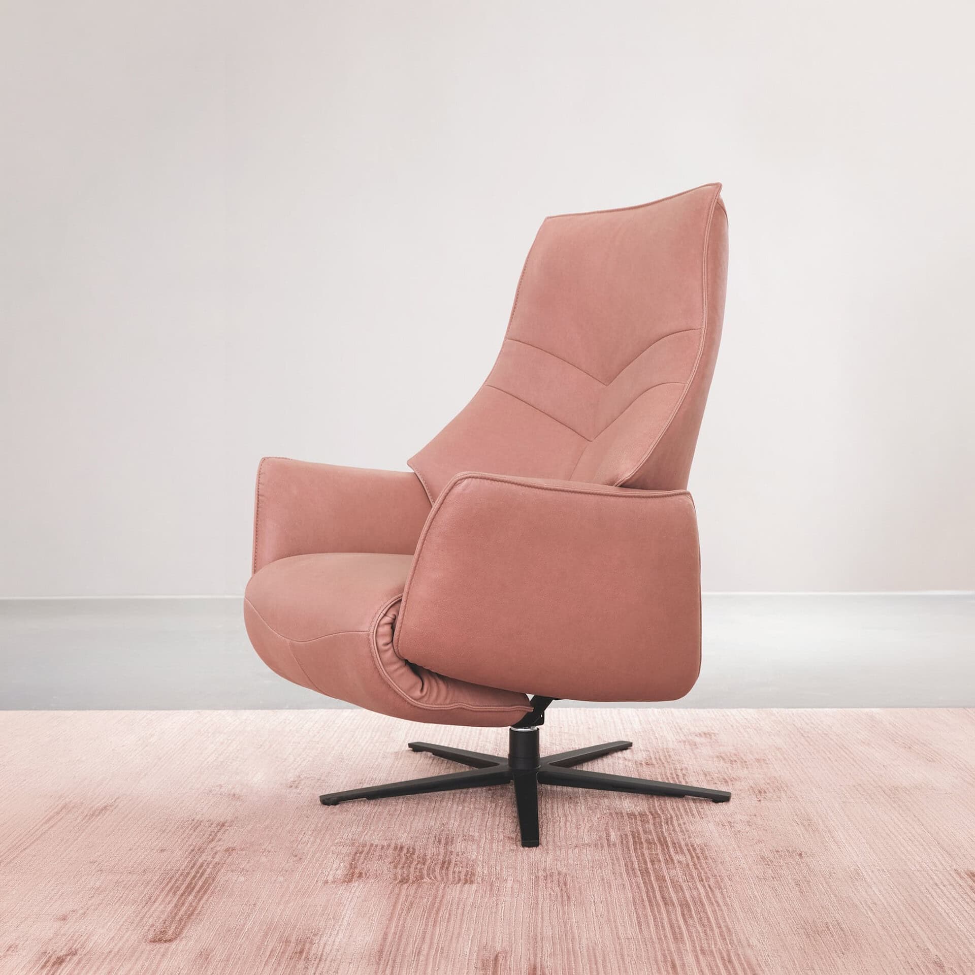 Recliner chair with plush pink upholstery, ergonomic design, and adjustable features for comfort.