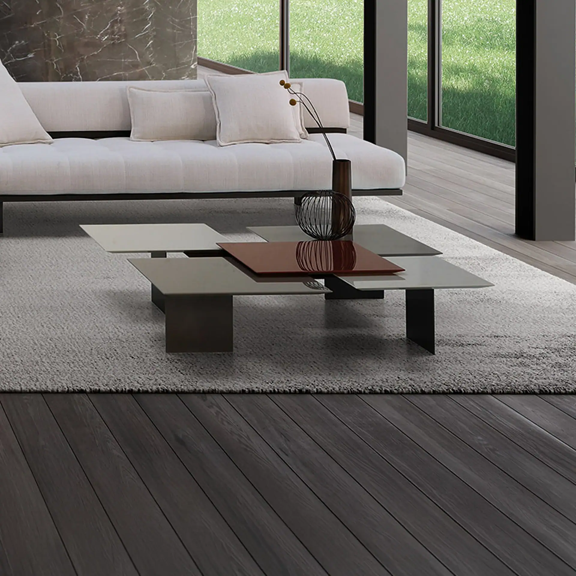 A modern living room with a cream sofa, a multi-level coffee table, and large windows.