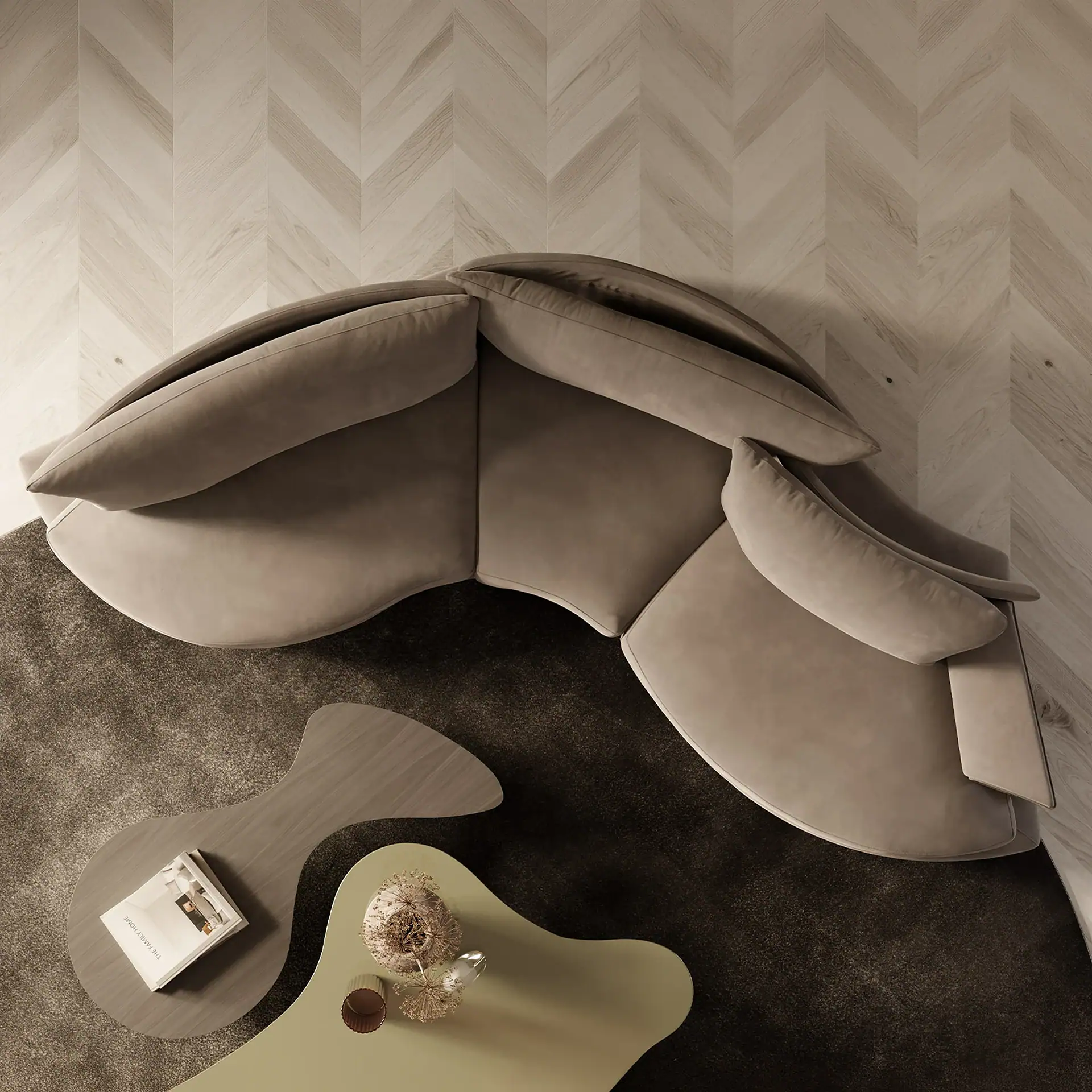 Overhead view of a living room with a Super Roy Modular Curved Sofa on a dark rug, two organic-shaped coffee tables with a book and dried flowers, and light herringbone wood flooring.