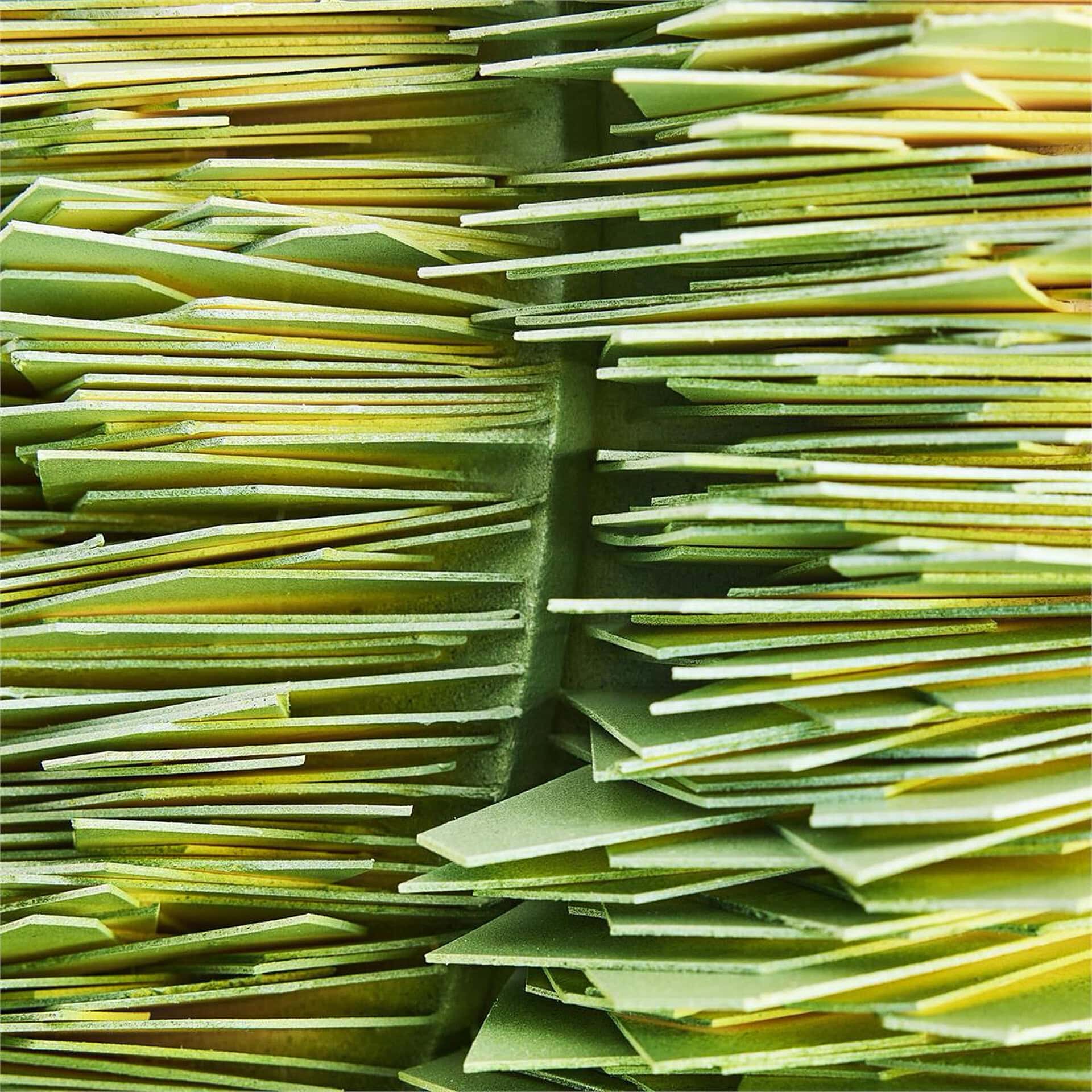 Rejuvenation dimensional wall art featuring layered green and yellow paper strips for modern interio.