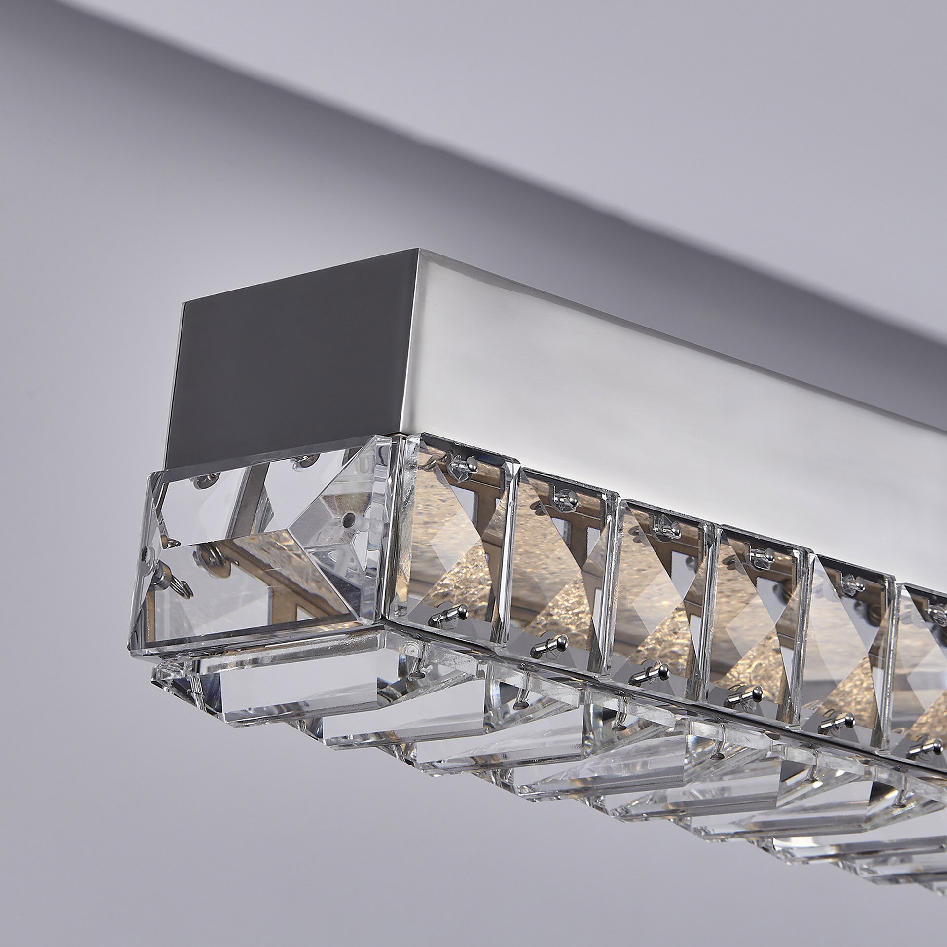 Pendant light with crystal accents and sleek metal finish.