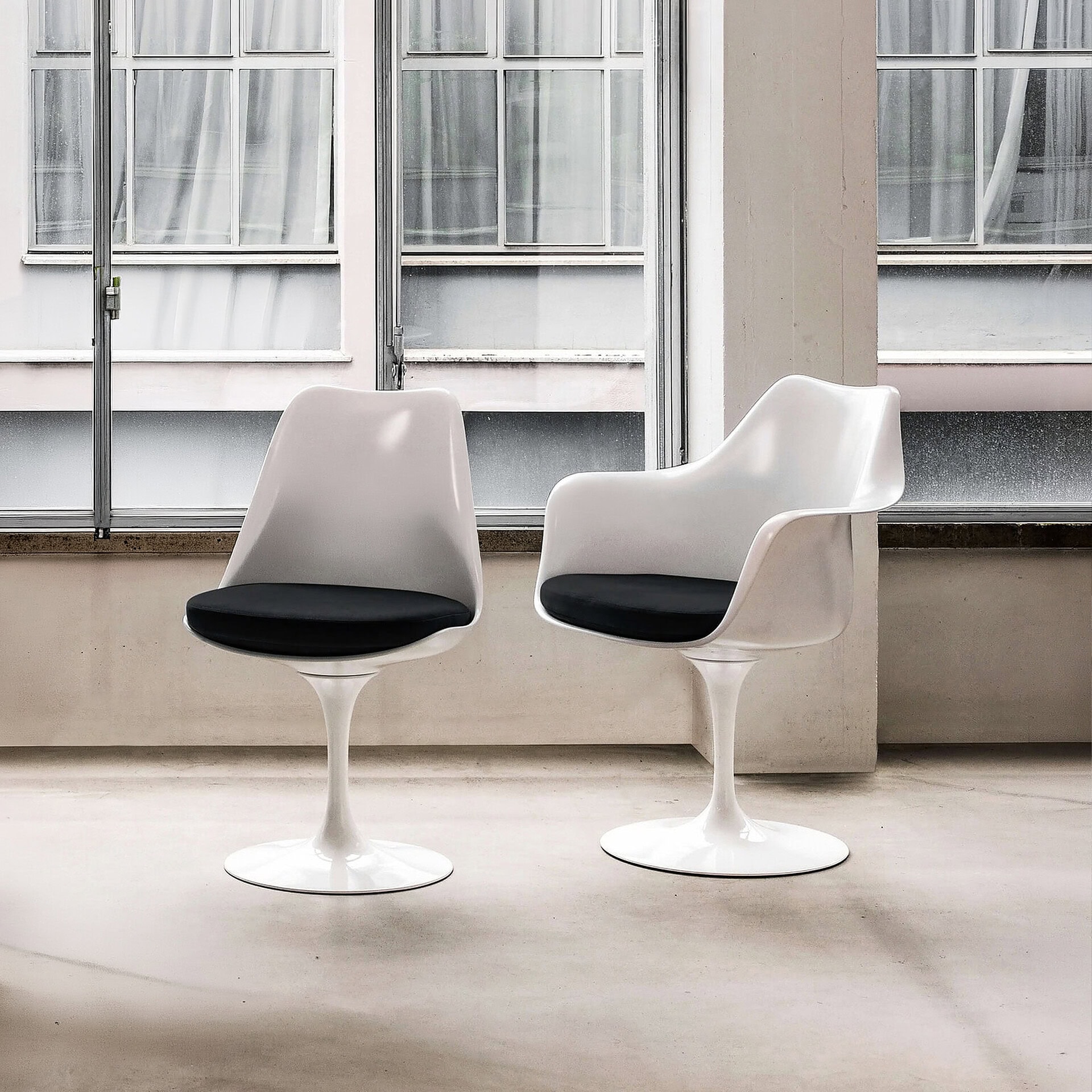 Elegant Tulip dining chair with white finish and black cushion, perfect for contemporary dining spac.