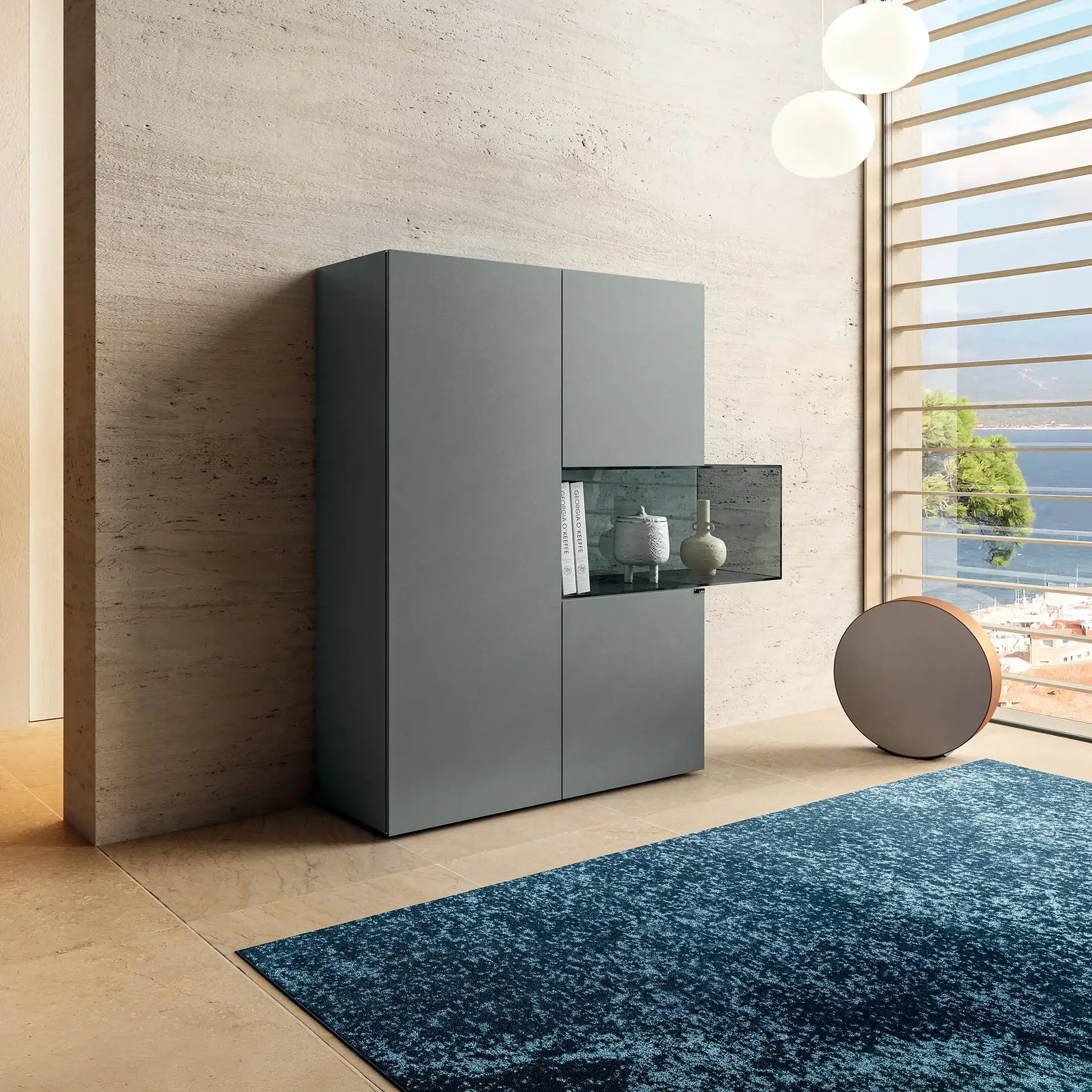 Sklar Furnishings modular glass sideboard in modern room with large window.