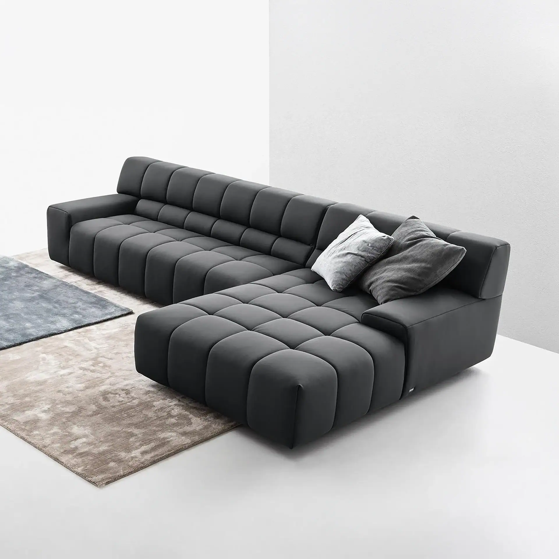 Contemporary black sectional sofa with plush cushions for stylish living room seating.