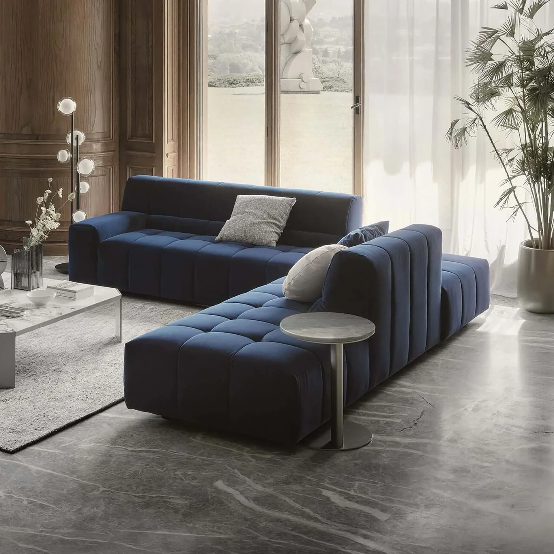 Navy blue velvet sectional sofa with plush cushions, perfect for contemporary living rooms.