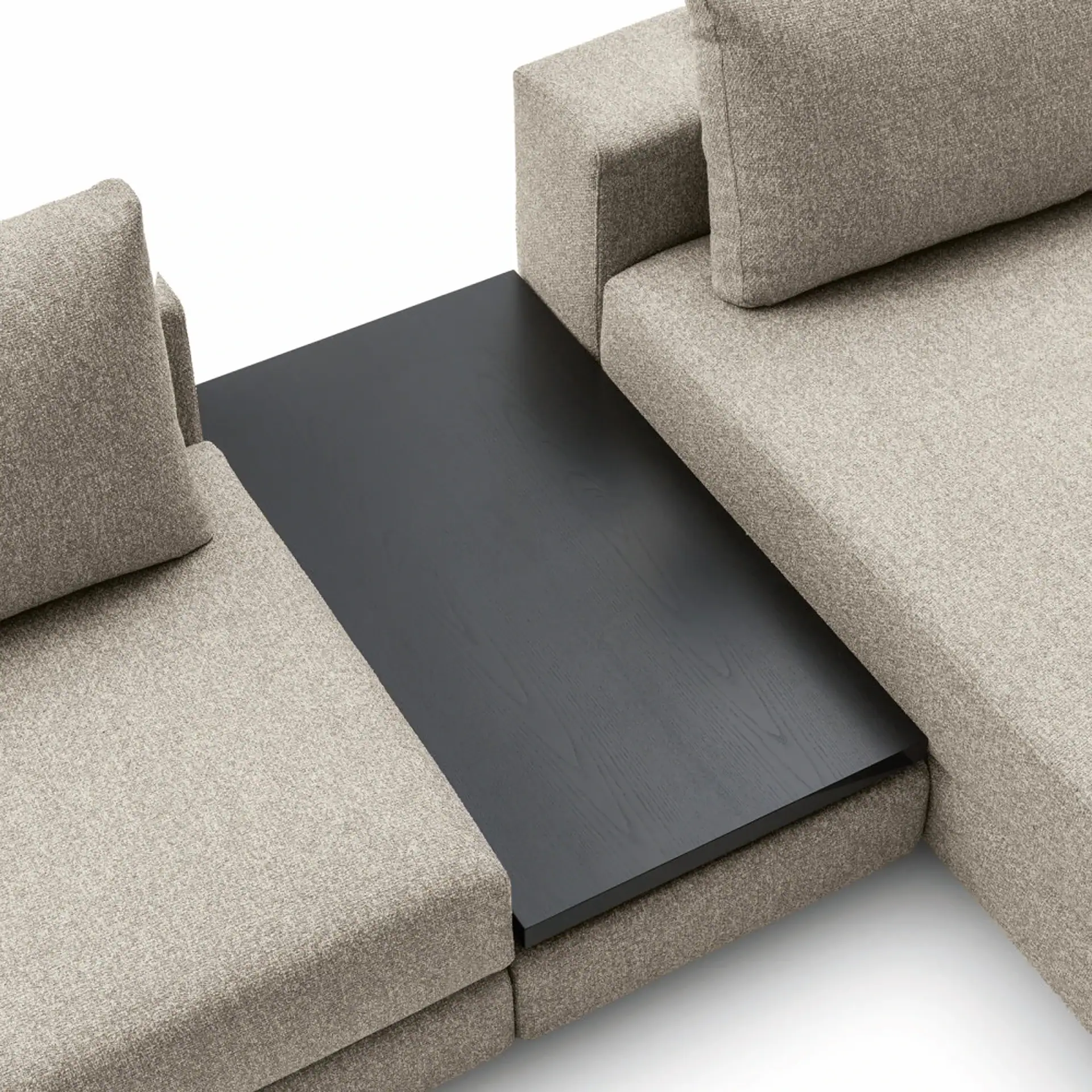 Top-down view of a light beige modular sofa with a dark wood panel integrated between two sections, forming an L-shape.