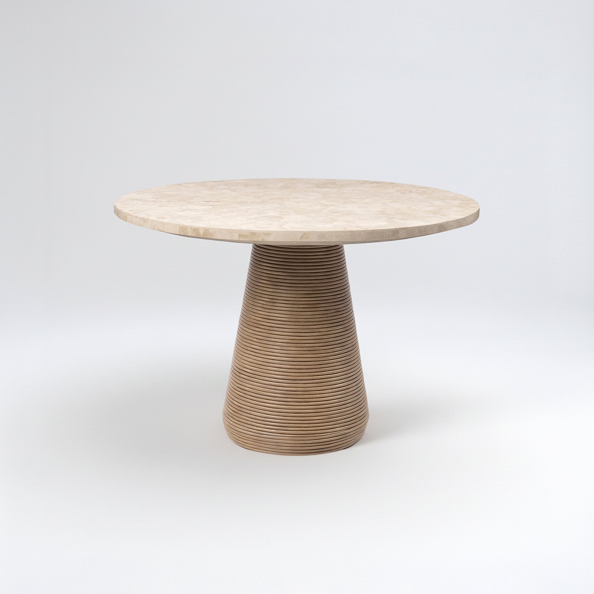 Round dining table with a textured base and marble top.